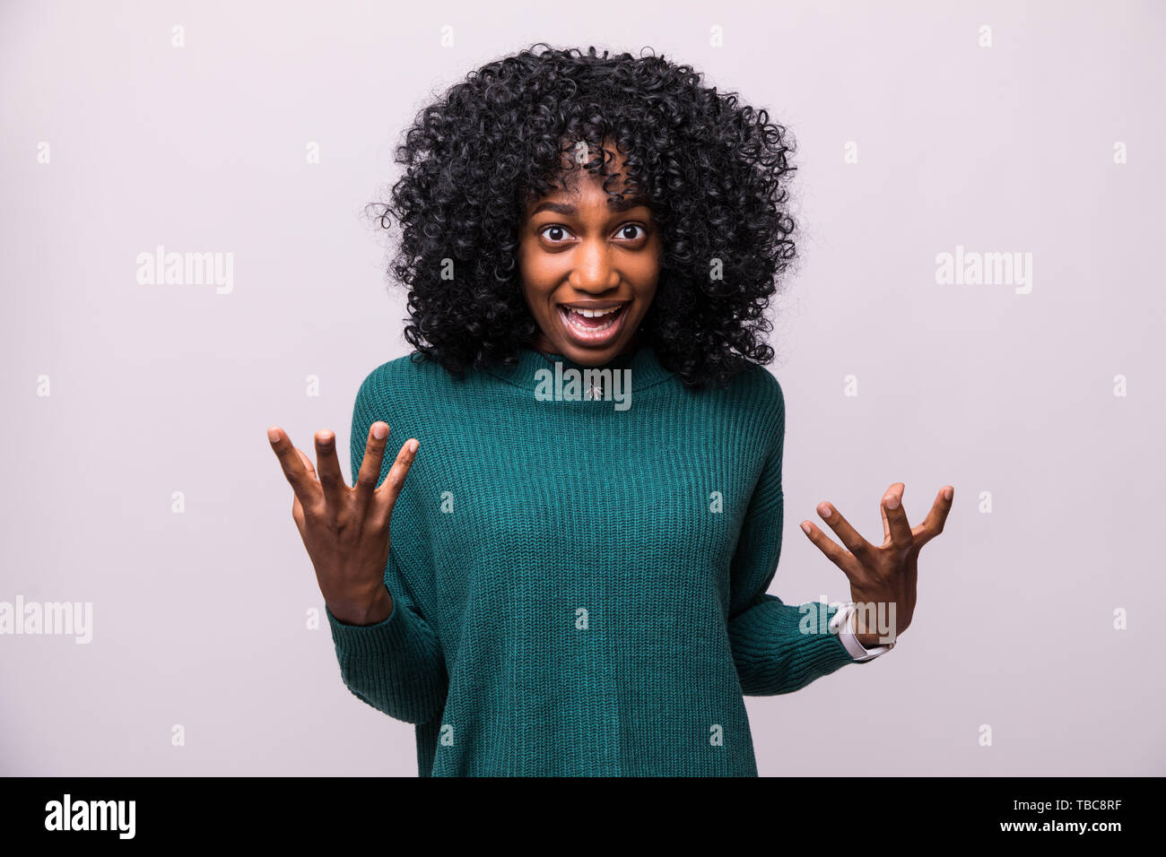 Enraged young woman with hands up yelling Stock Photo