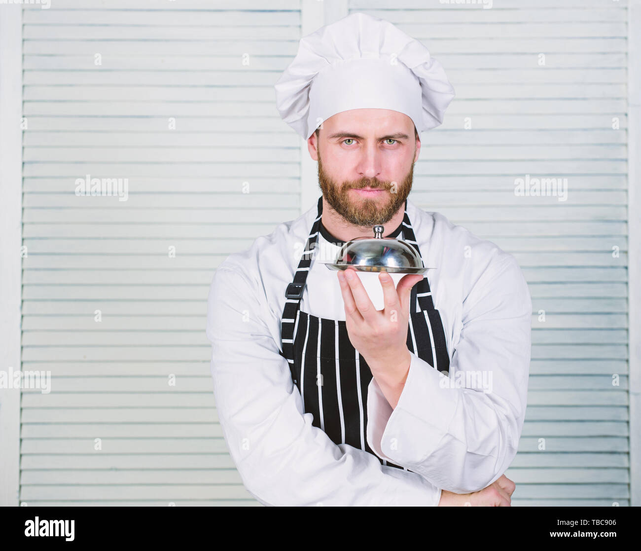 https://c8.alamy.com/comp/TBC906/man-cook-hat-and-apron-hold-meal-covered-with-lid-delicious-meal-presentation-haute-cuisine-characterized-meticulous-preparation-and-careful-presentation-meal-secret-meal-presentation-chefs-dish-TBC906.jpg