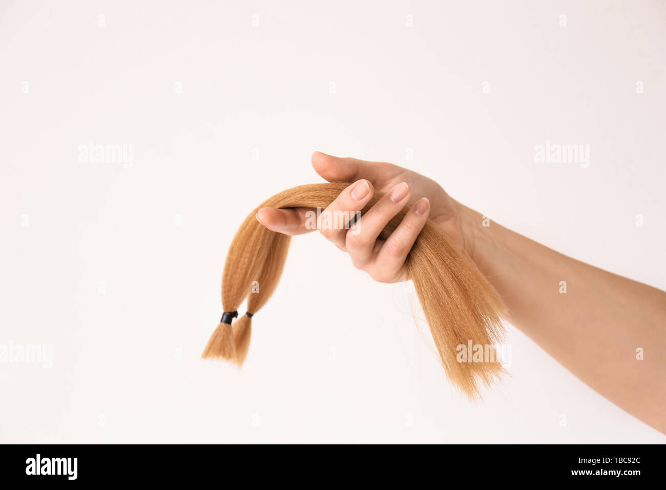 Female Hand With Hair Strands On Light Background Concept Of