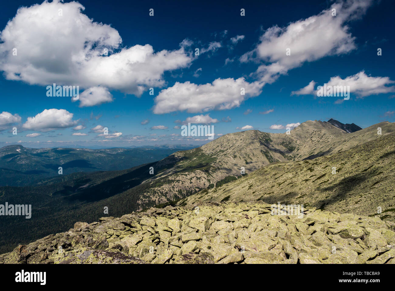 Rocks under blue sky with clouds. View of mountain valley. Tourism ...