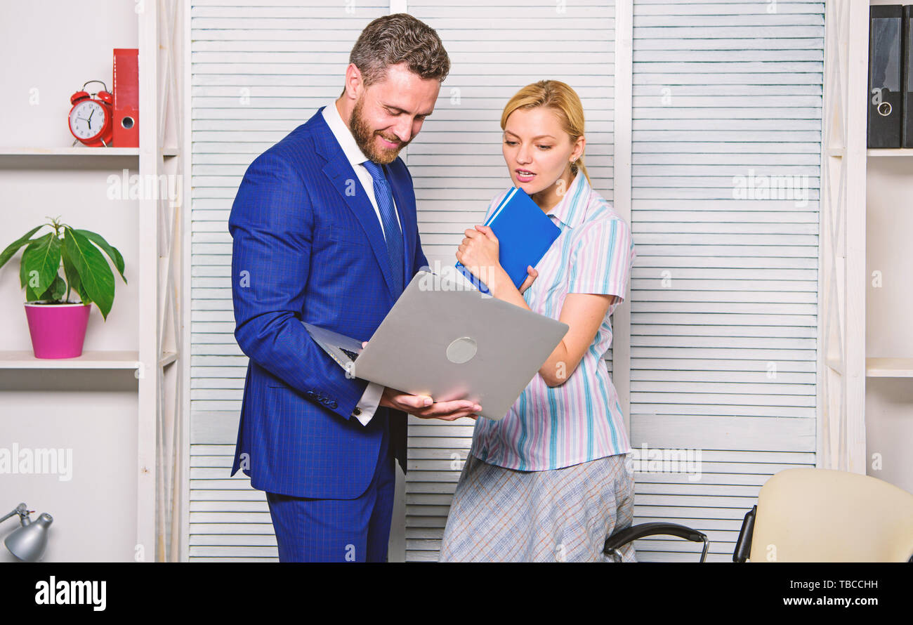 Ask opinion of colleague. Businessman hold laptop surfing internet. Boss  and secretary or assistant work laptop. Teamwork and support. Office  business partner show information data statistics online Stock Photo - Alamy