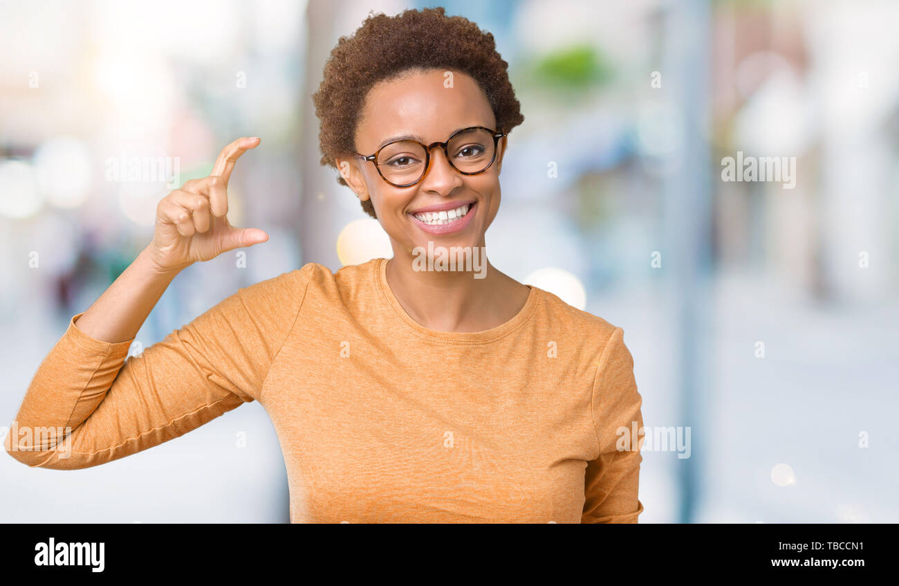 Young beautiful african american woman wearing glasses over isolated ...
