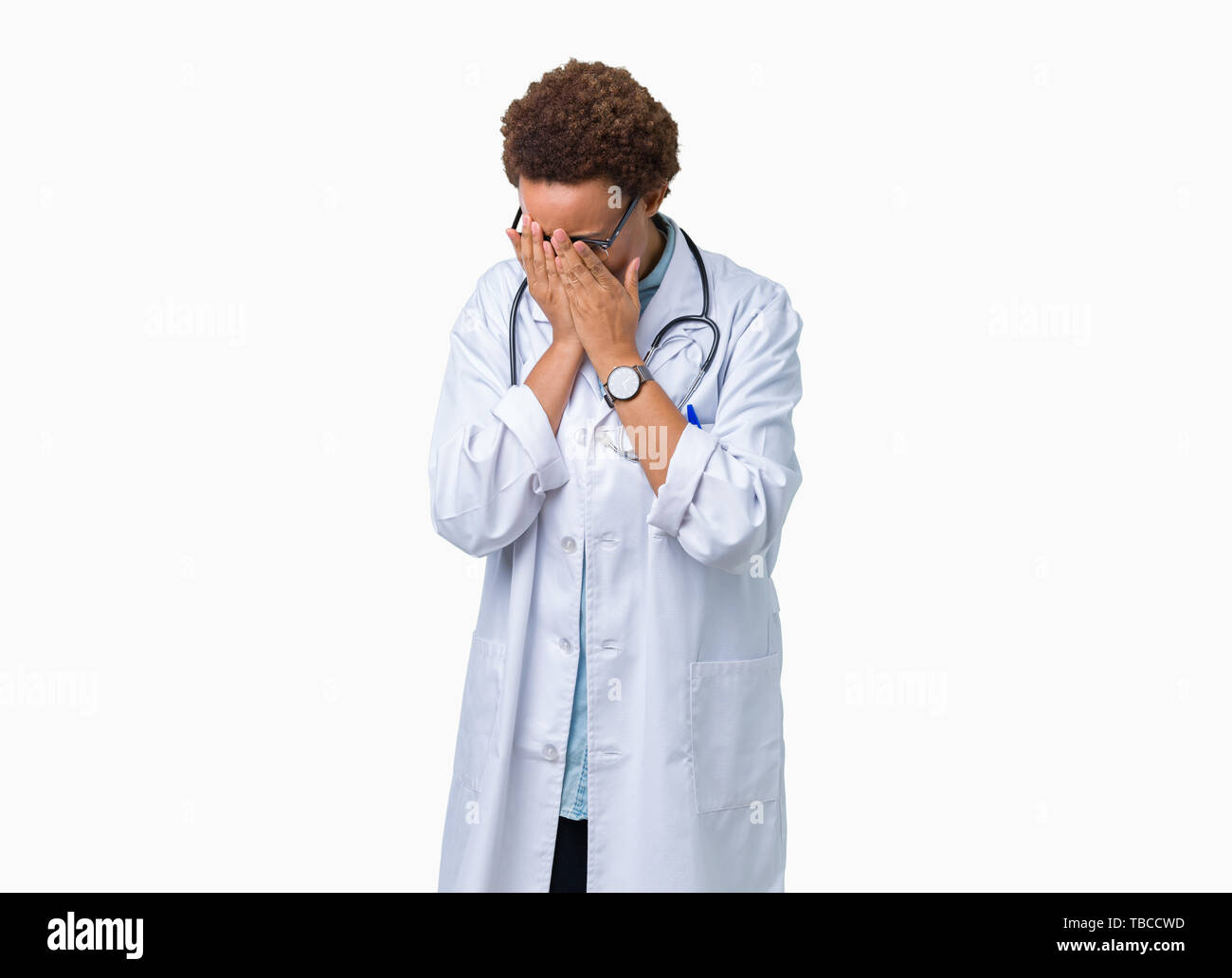 Young african american doctor woman wearing medical coat over isolated background with sad expression covering face with hands while crying. Depressio Stock Photo