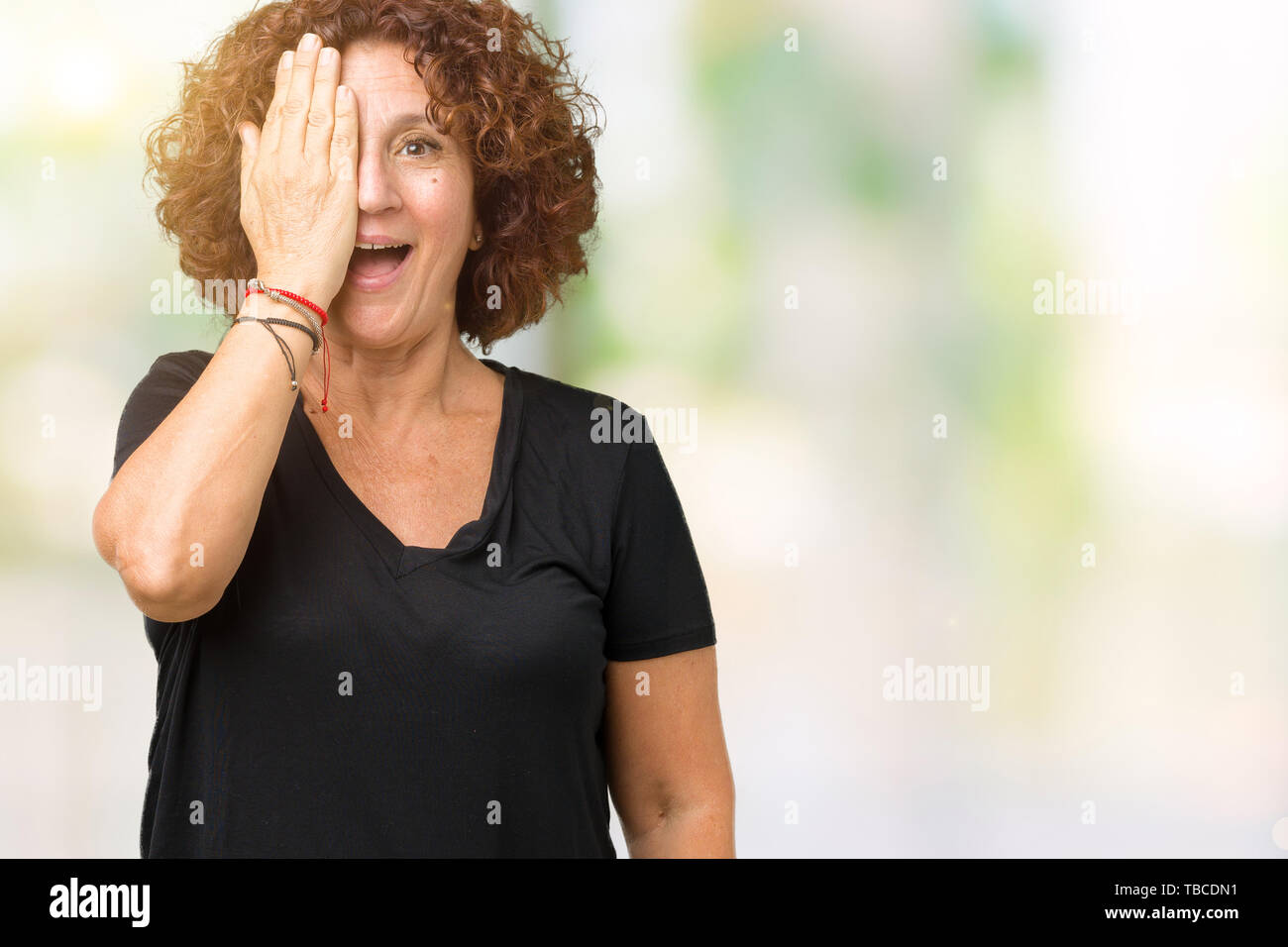 Beautiful middle ager senior woman over isolated background covering