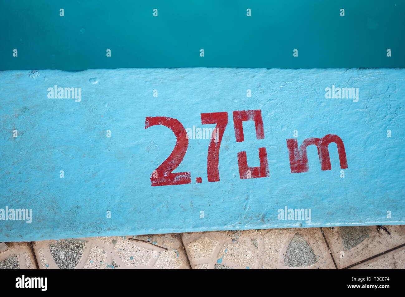 Swimming pool with 2.70m depth marker painted in red Stock Photo