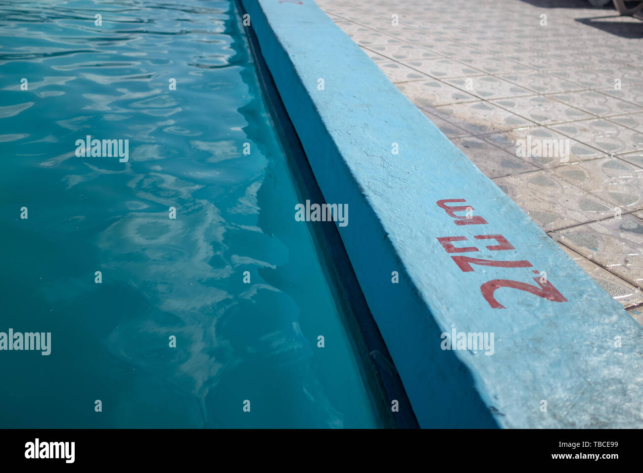Inviting blue pool with 2.70m depth marking Stock Photo