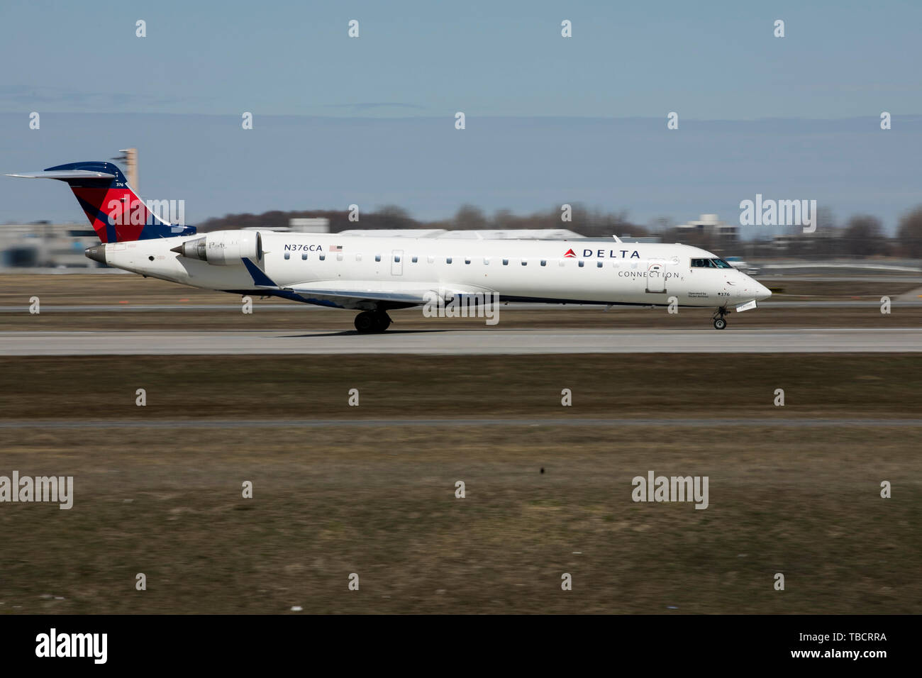 A Delta Connection Bombardier CRJ700 airplane is seen departing Montréal-Pierre Elliott Trudeau International Airport in Montreal, Quebec, Canada, on  Stock Photo