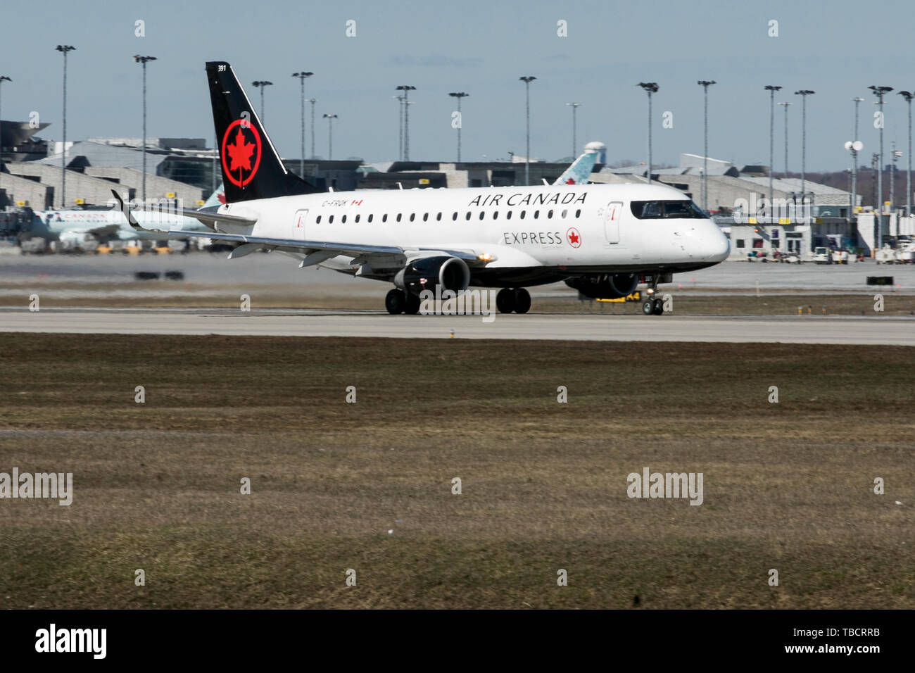 A Air Canada Express Embraer ERJ170 airplane is seen departing Montreal Pierre Elliott Trudeau International Airport in Montreal, Quebec, Canada, on A Stock Photo