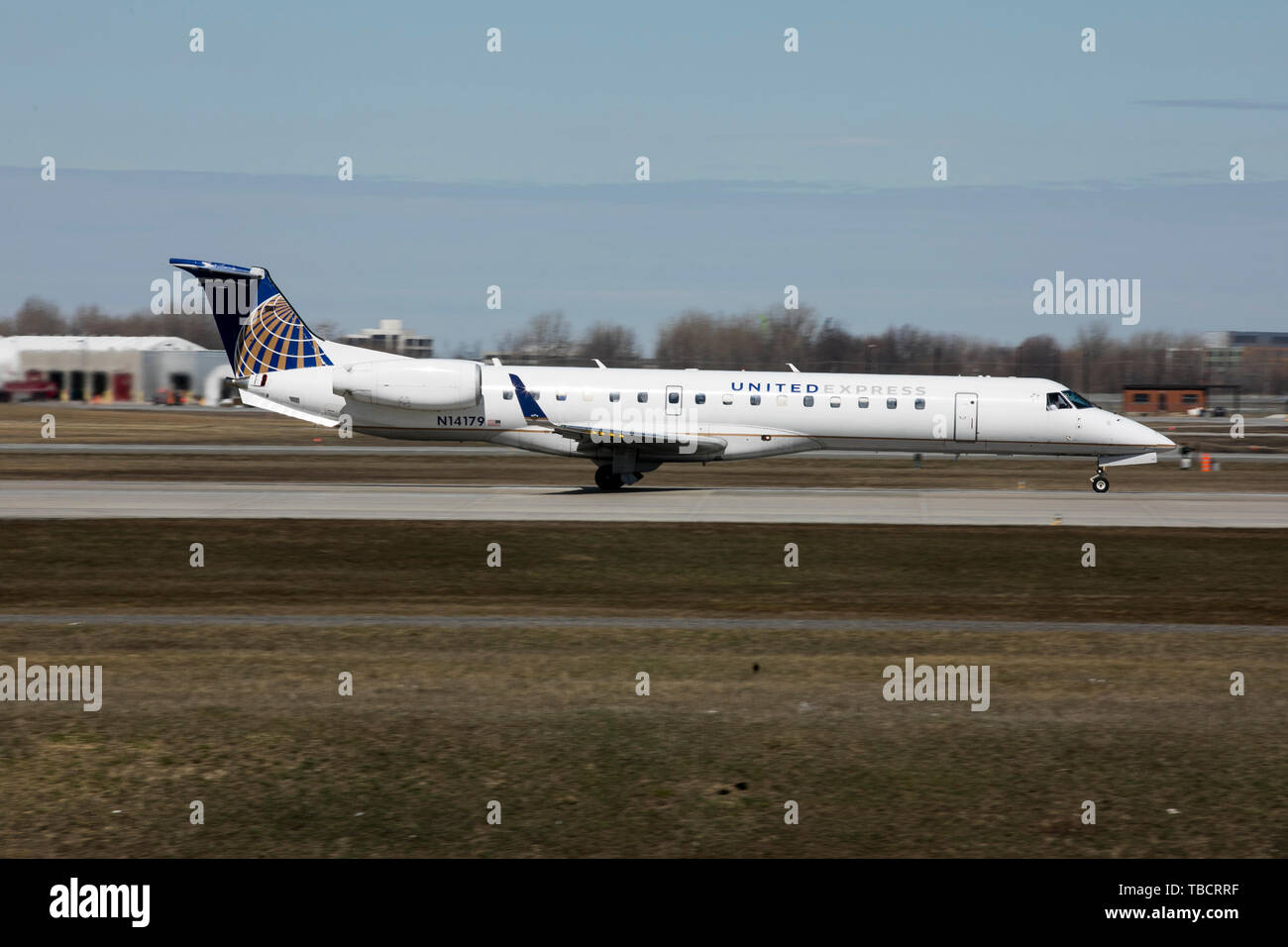 A United Express Embraer ERJ145 airplane is seen departing Montréal-Pierre Elliott Trudeau International Airport in Montreal, Quebec, Canada, on April Stock Photo
