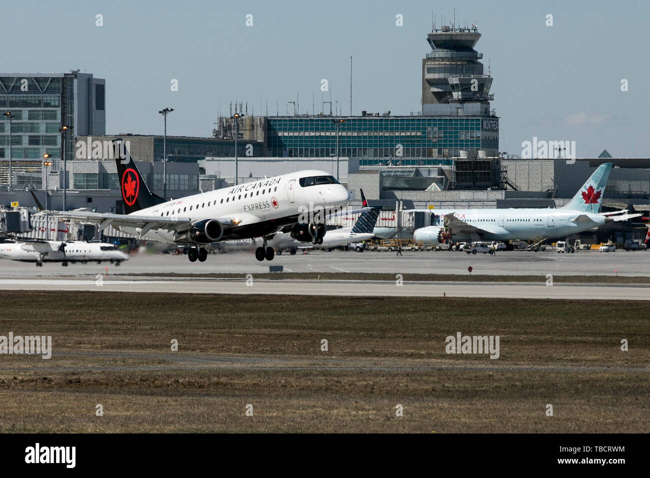 A Air Canada Express Embraer ERJ170 airplane is seen landing at Montréal-Pierre Elliott Trudeau International Airport in Montreal, Quebec, Canada, on  Stock Photo