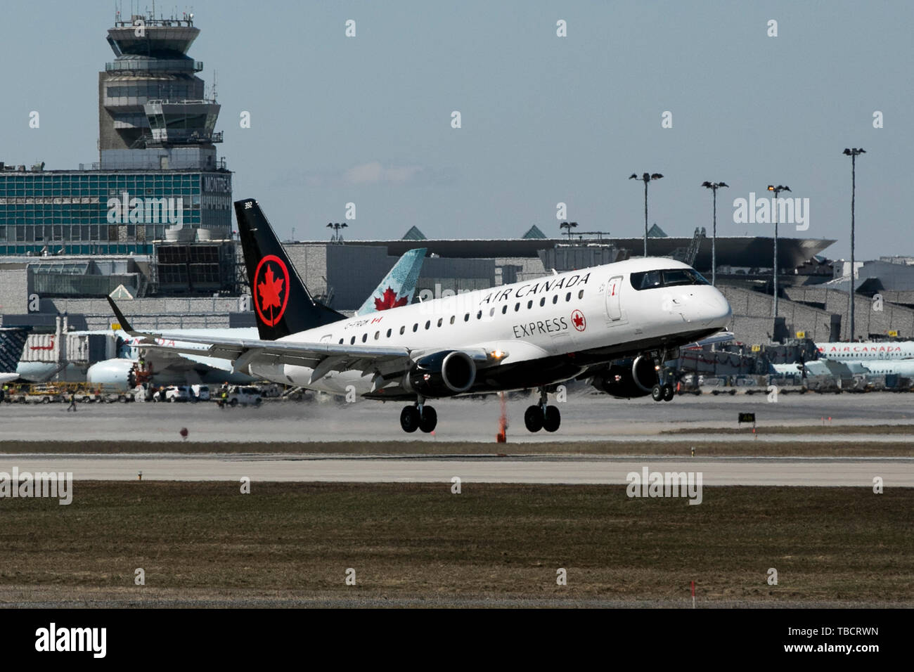 A Air Canada Express Embraer ERJ170 airplane is seen landing at Montréal-Pierre Elliott Trudeau International Airport in Montreal, Quebec, Canada, on  Stock Photo