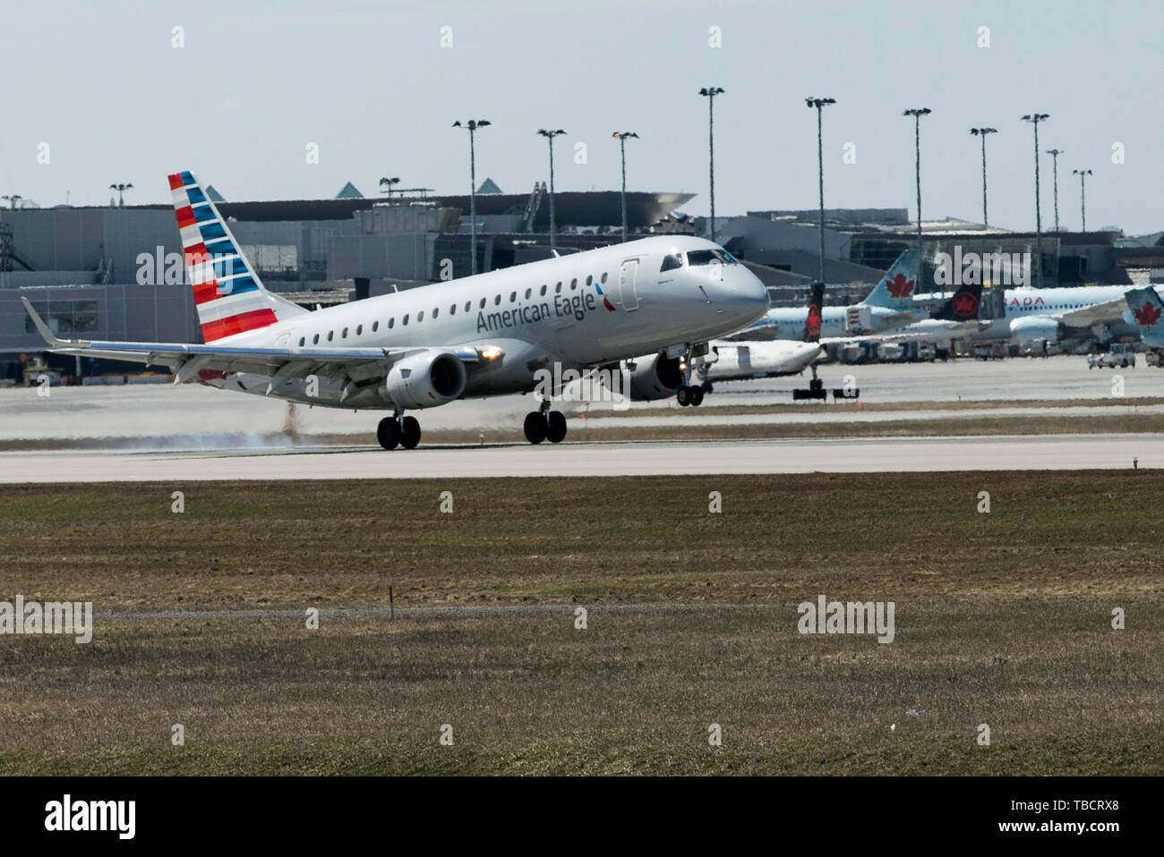 A American Eagle Embraer ERJ 170 airplane is seen landing at Montréal-Pierre Elliott Trudeau International Airport in Montreal, Quebec, Canada, on Apr Stock Photo