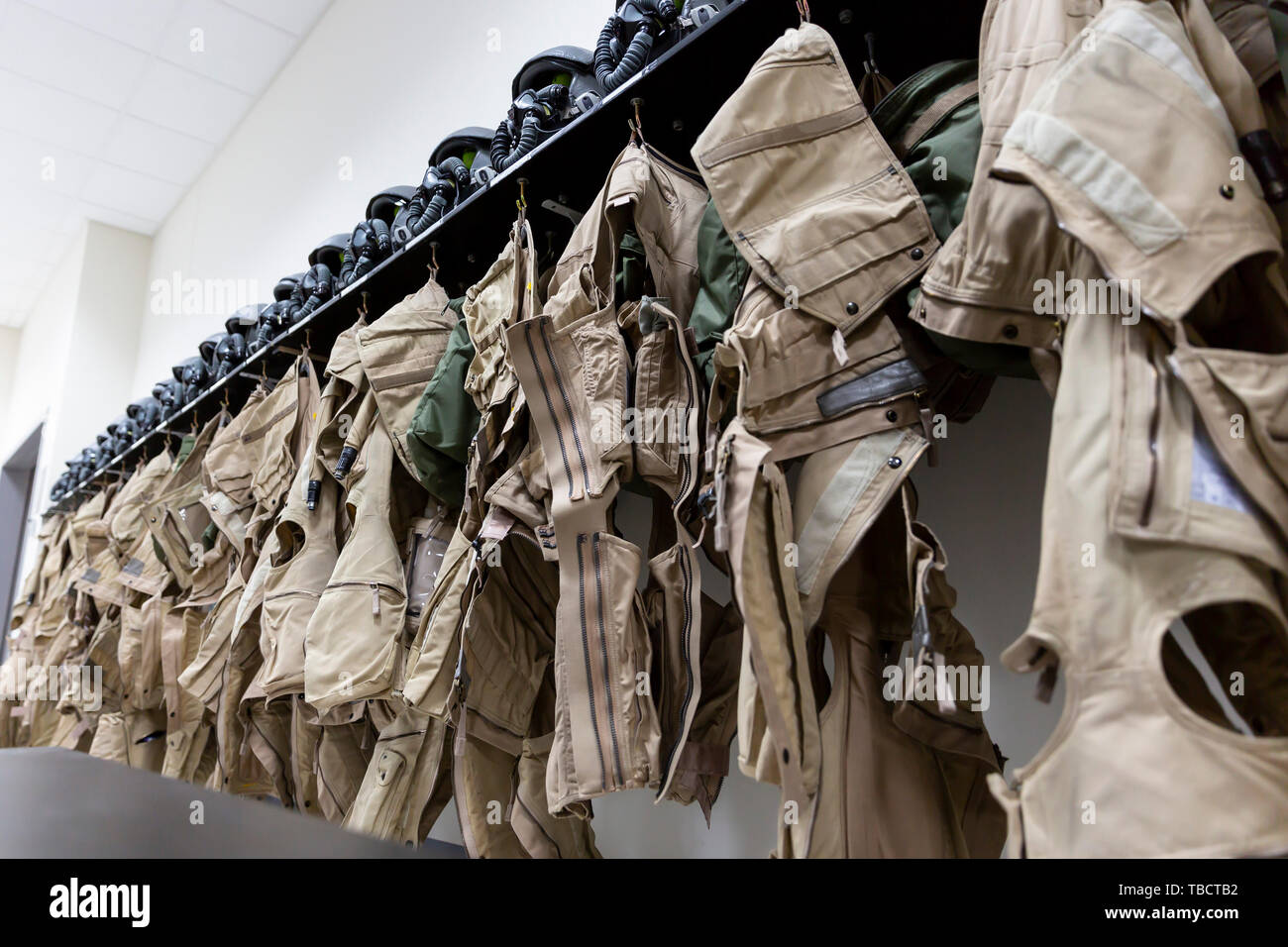 Dressing room of a fighter aircraft (jet fighter) pilot with uniforms