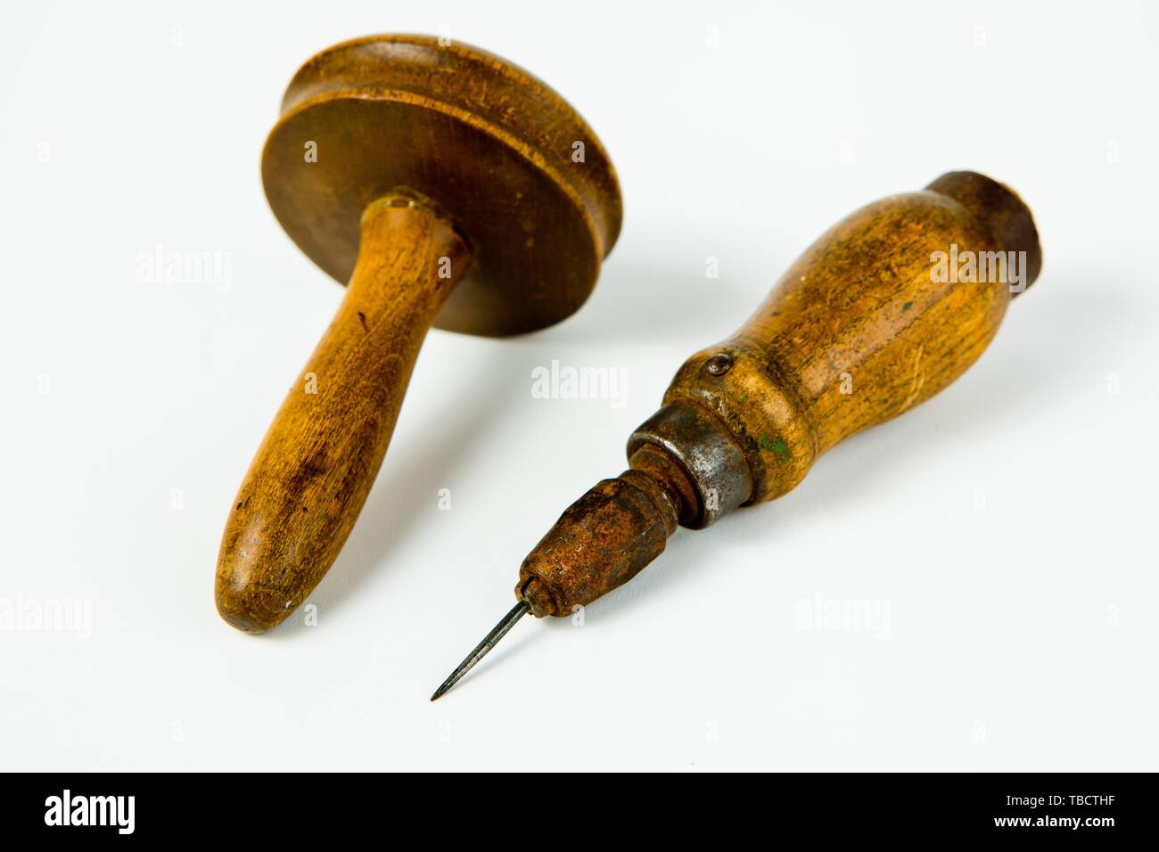 Vintage rusty awl with wooden grip and darning tool, old tailor's tools Stock Photo