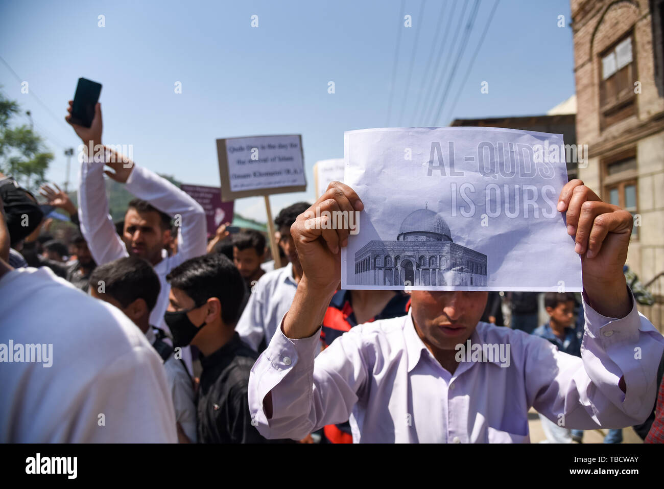 A Kashmiri Shiite Muslim holds a placard during an annual rally marking ...