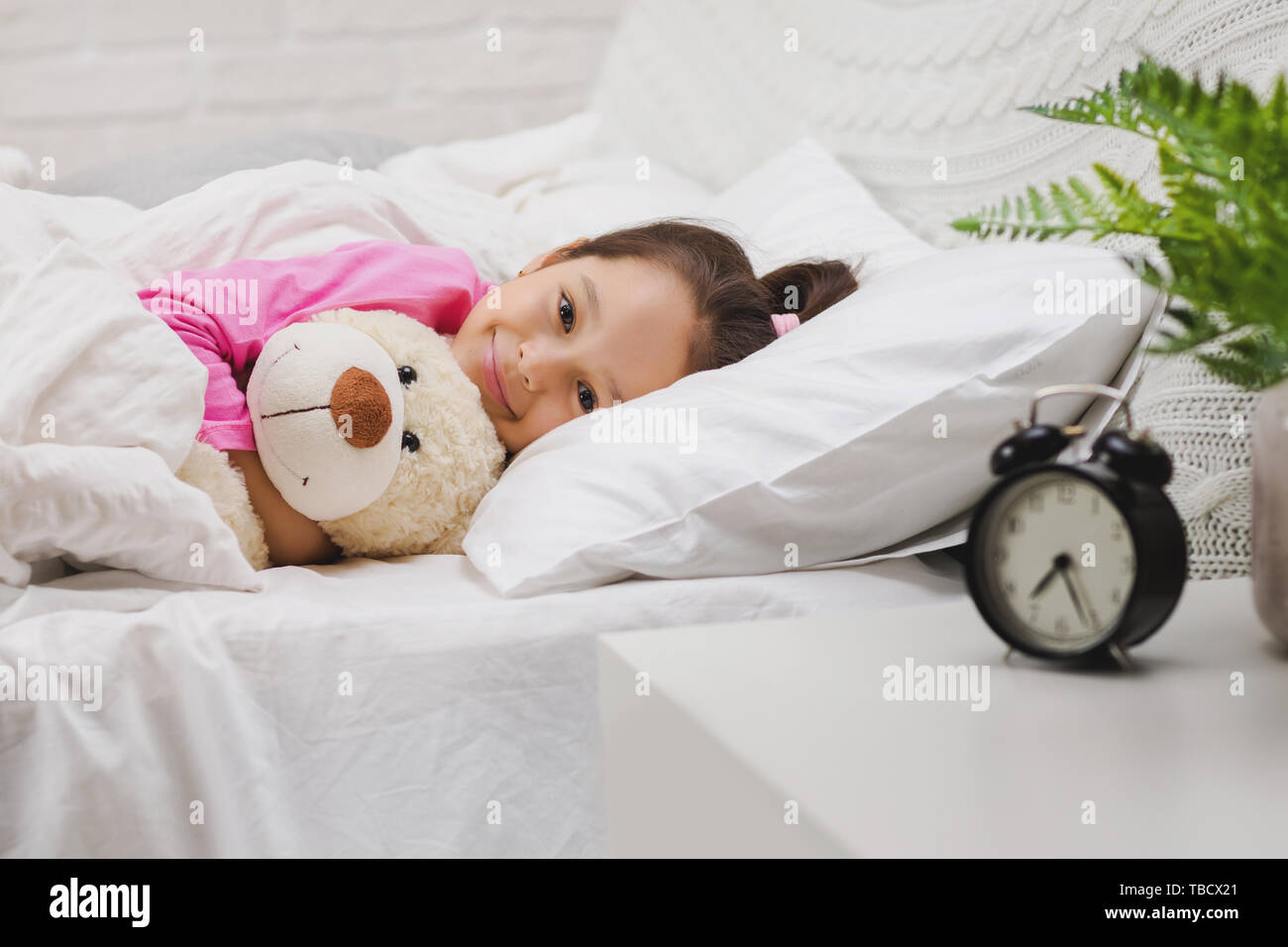 Cute happy little child girl sleeping with teddy bear in her bed Stock ...