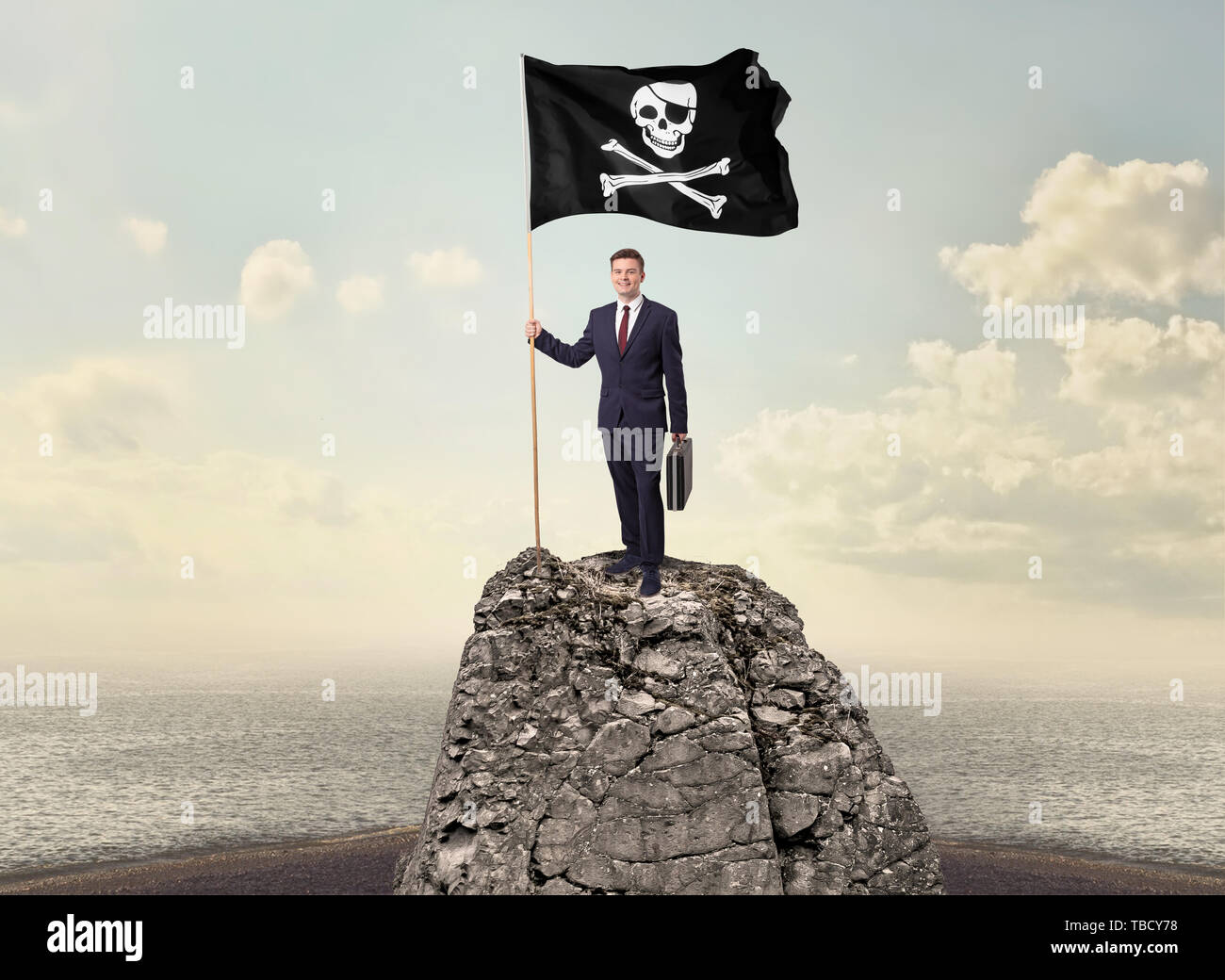 Successful businessman on the top of a mountain holding pirate flag ...