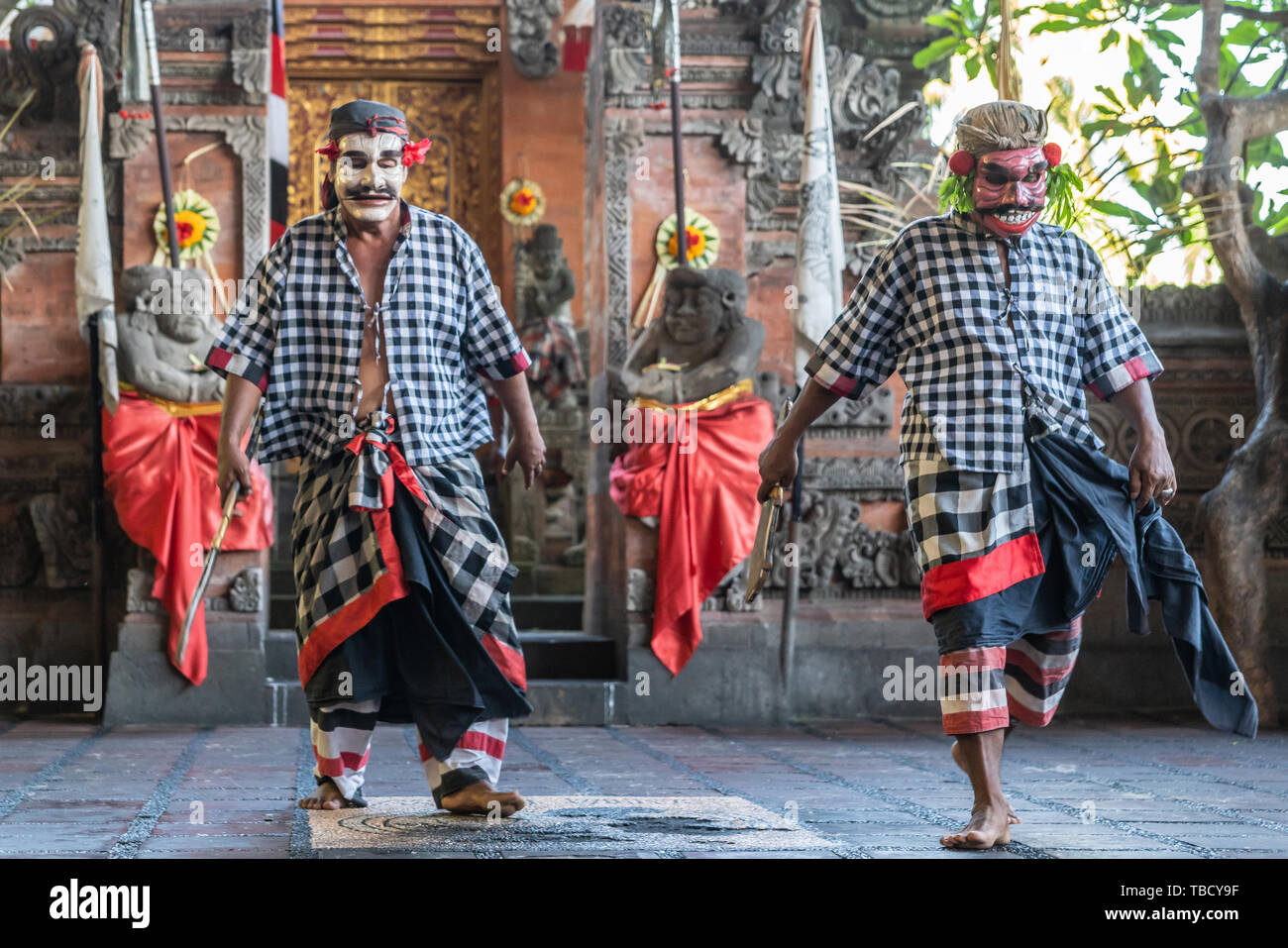 Banjar Gelulung, Bali, Indonesia - February 26, 2019: Mas Village. Play on stage setting. Two bandits dance dressed with gray-white checkered shirts. Stock Photo