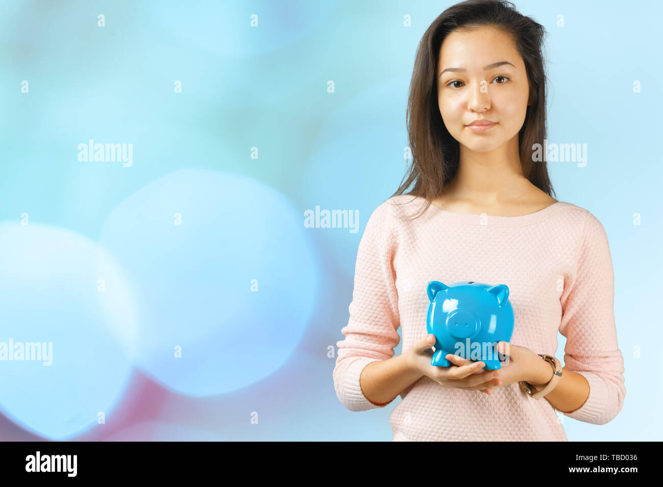 Woman holding piggy bank Stock Photo - Alamy