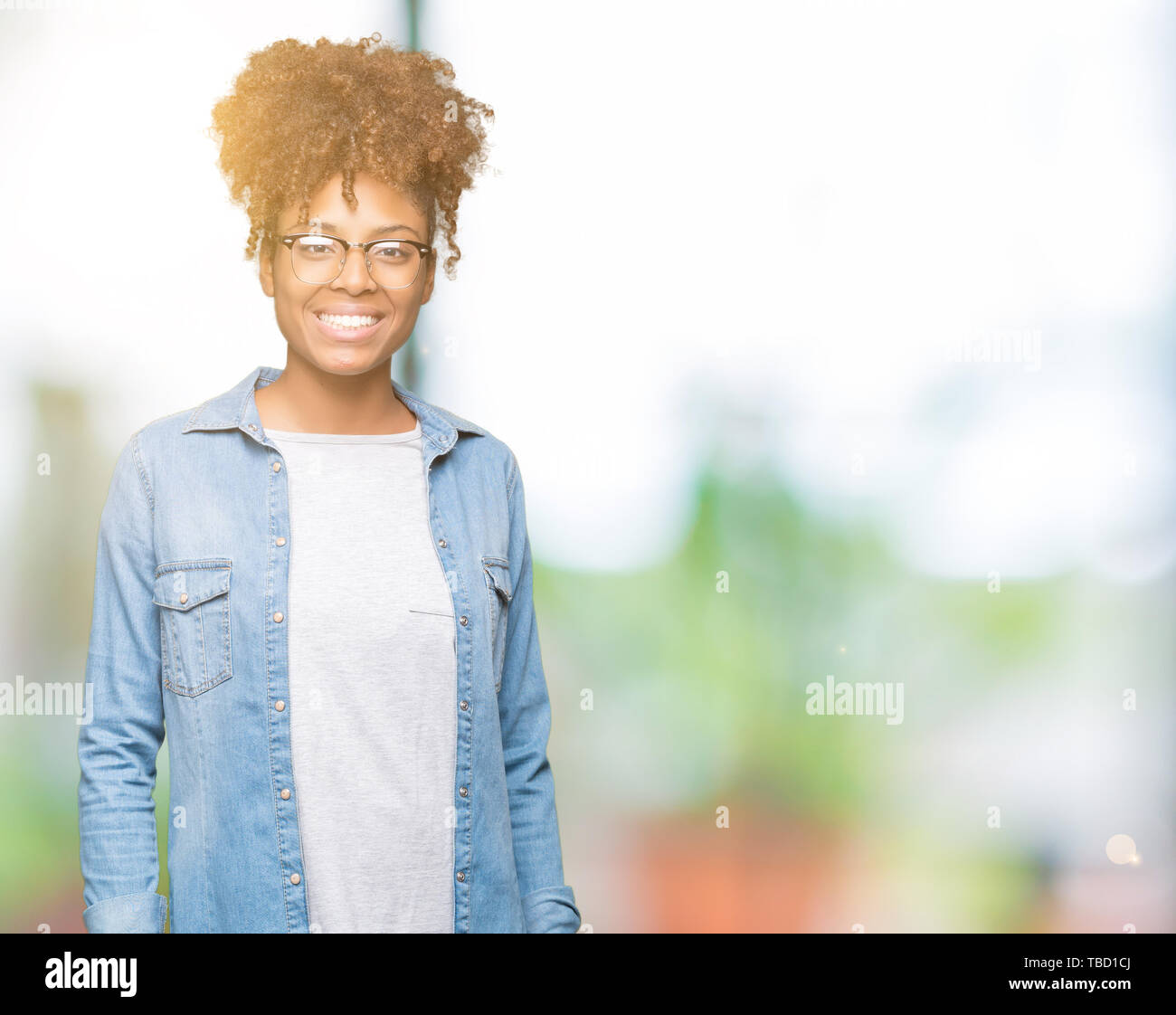 Beautiful young african american woman wearing glasses over isolated ...