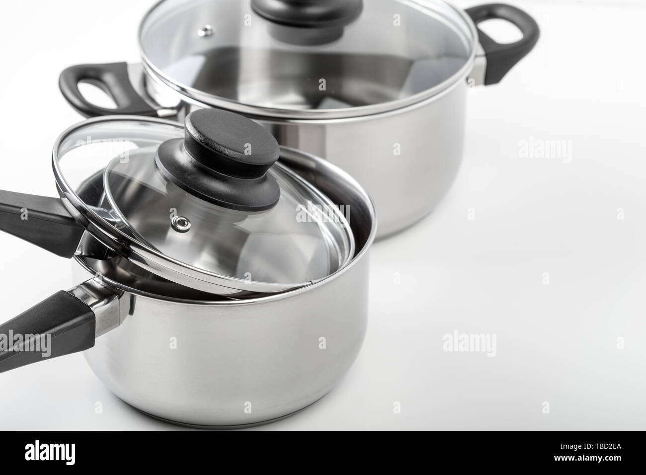 Stainless steel pots and pans isolated on white Stock Photo Alamy