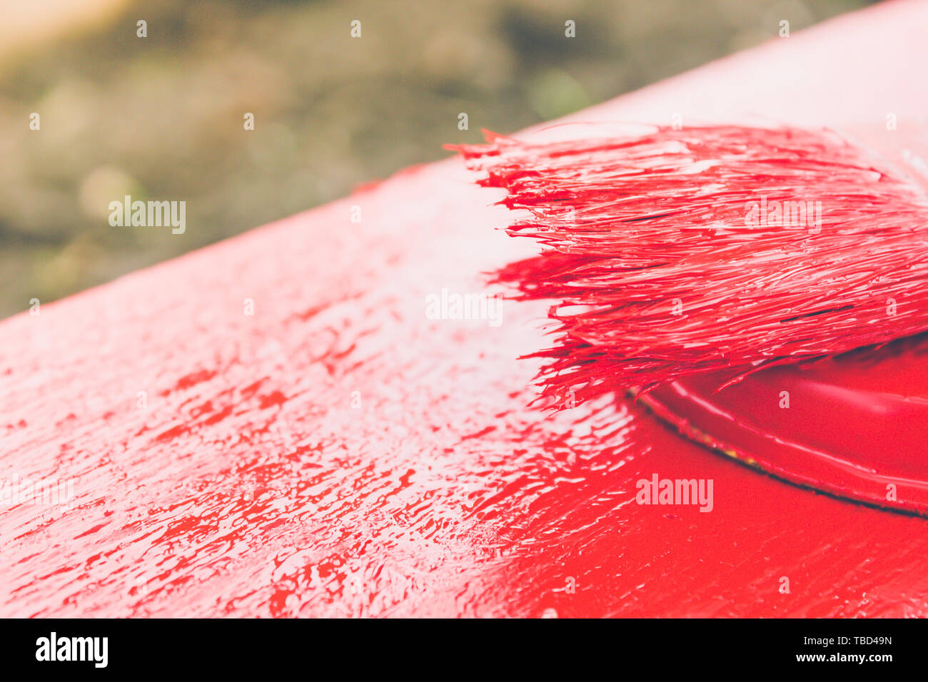 Paint brush with red paint. To paint the board of girls. Painting works