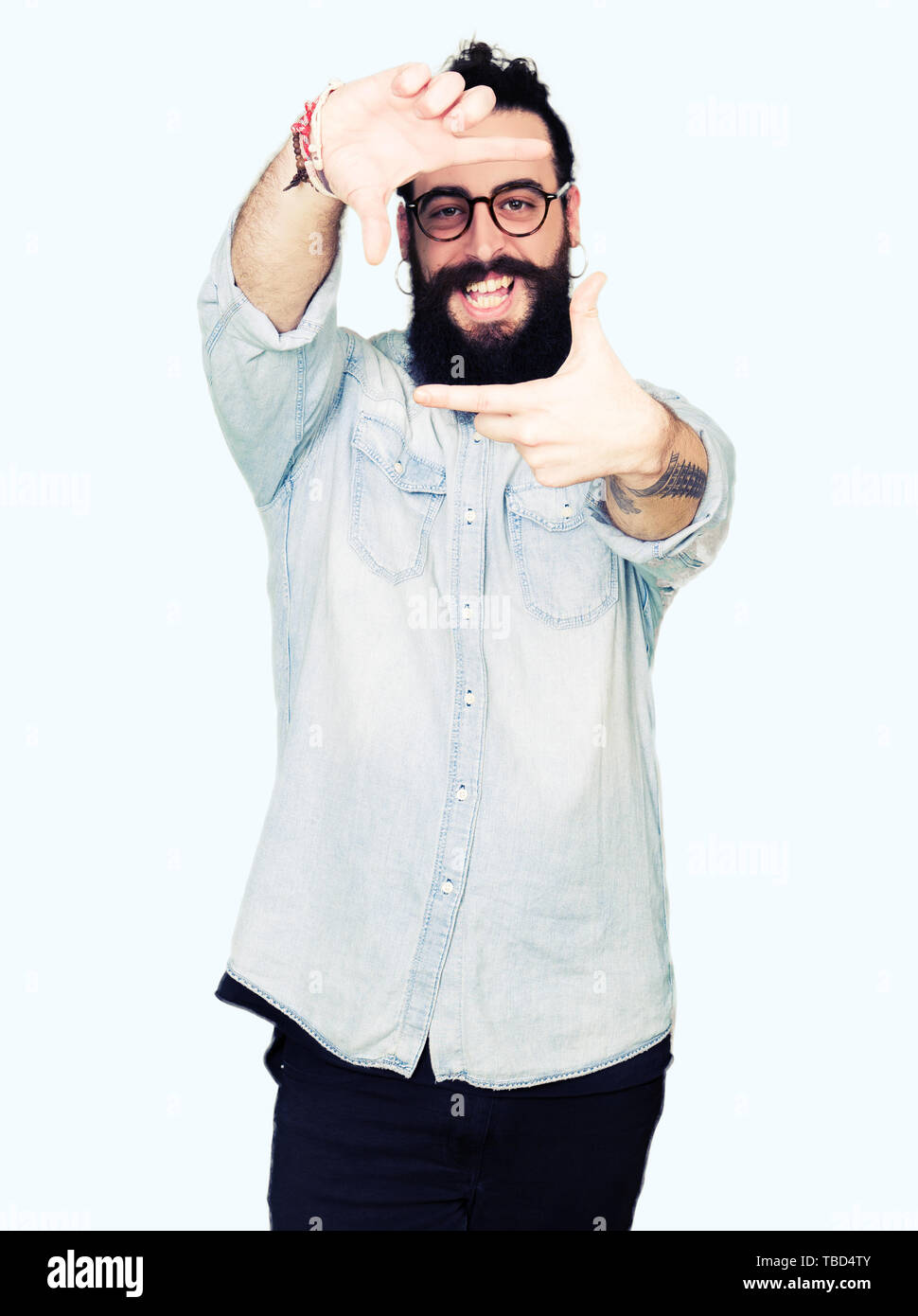 Young Hipster Man With Long Hair And Beard Wearing Glasses Smiling