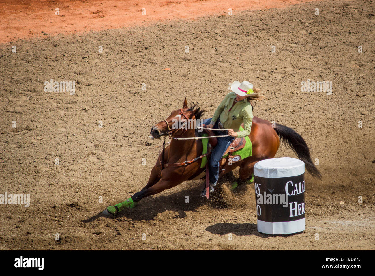 Cowgirl rides horse in barrel racing competition even at Calgary