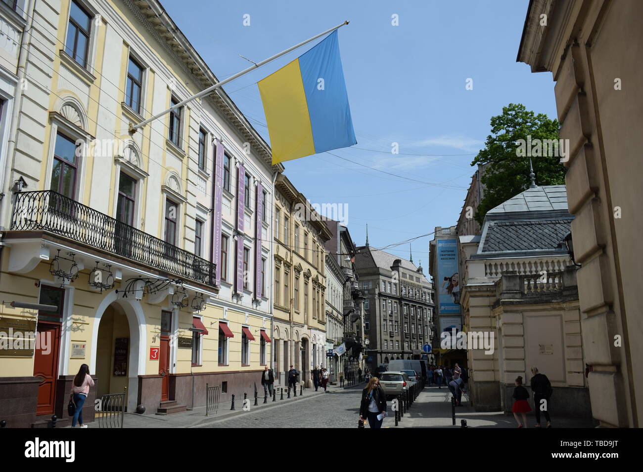 Ukraine, Lviv - May, 2019 Flag of Ukraine on pole on building wall in Lviv. Stock Photo