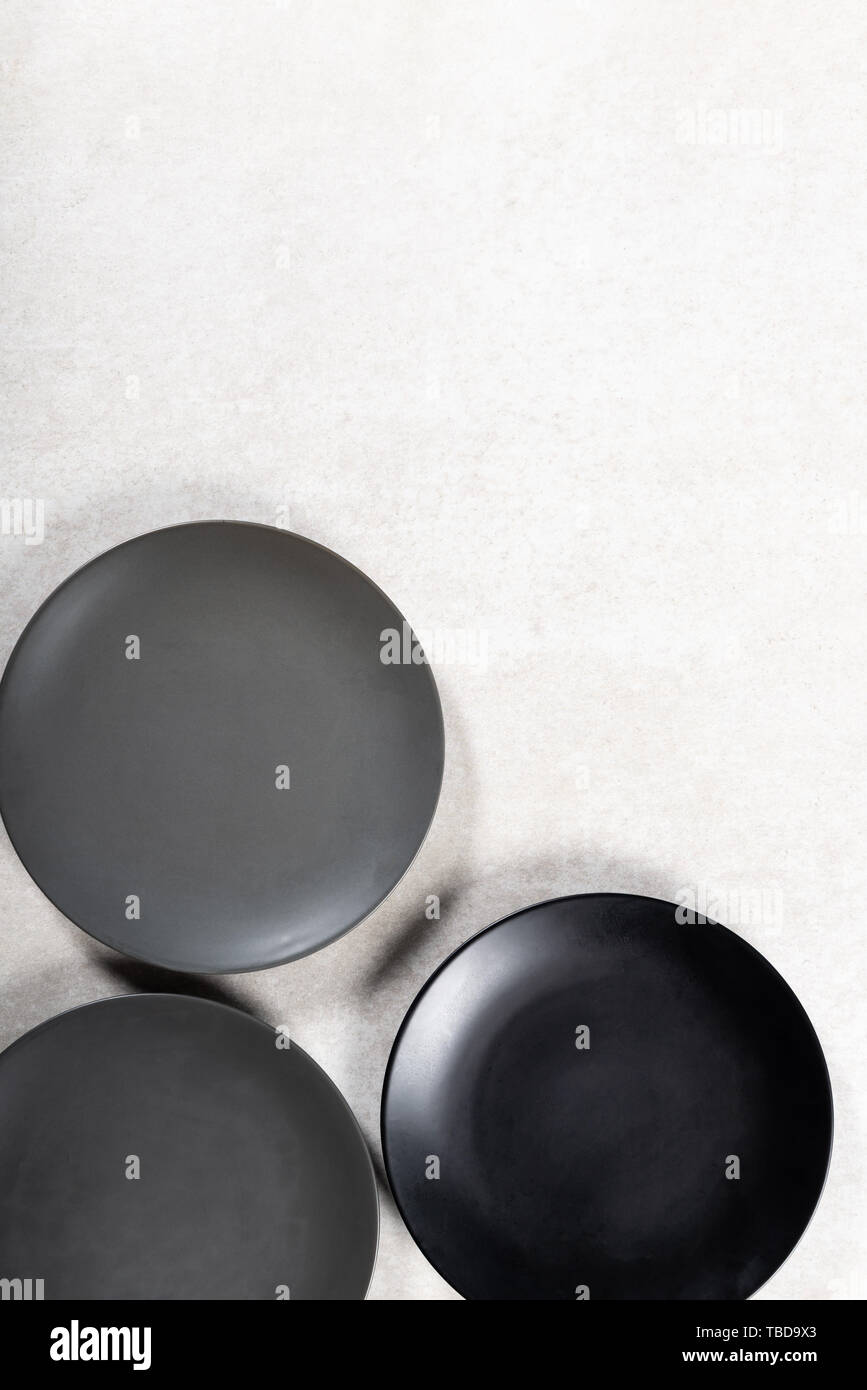 Empty Black and Grey Plates on Grey Background, Top View, Copy Space Stock Photo