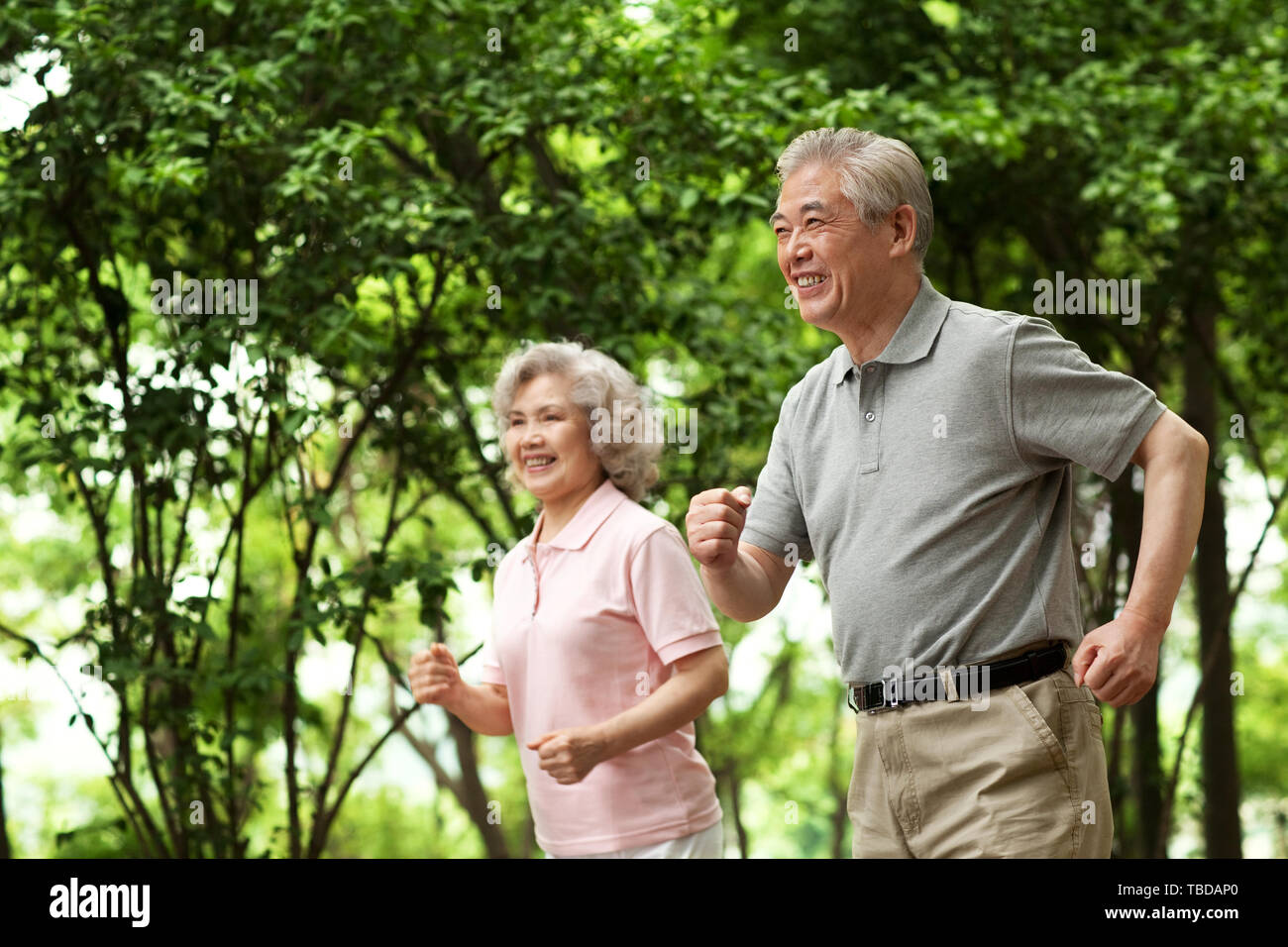 An elderly couple working out in a park Stock Photo