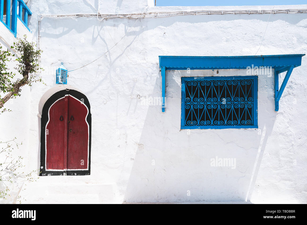 Traditional Red Doors And Blue Windows On The White Houses On The