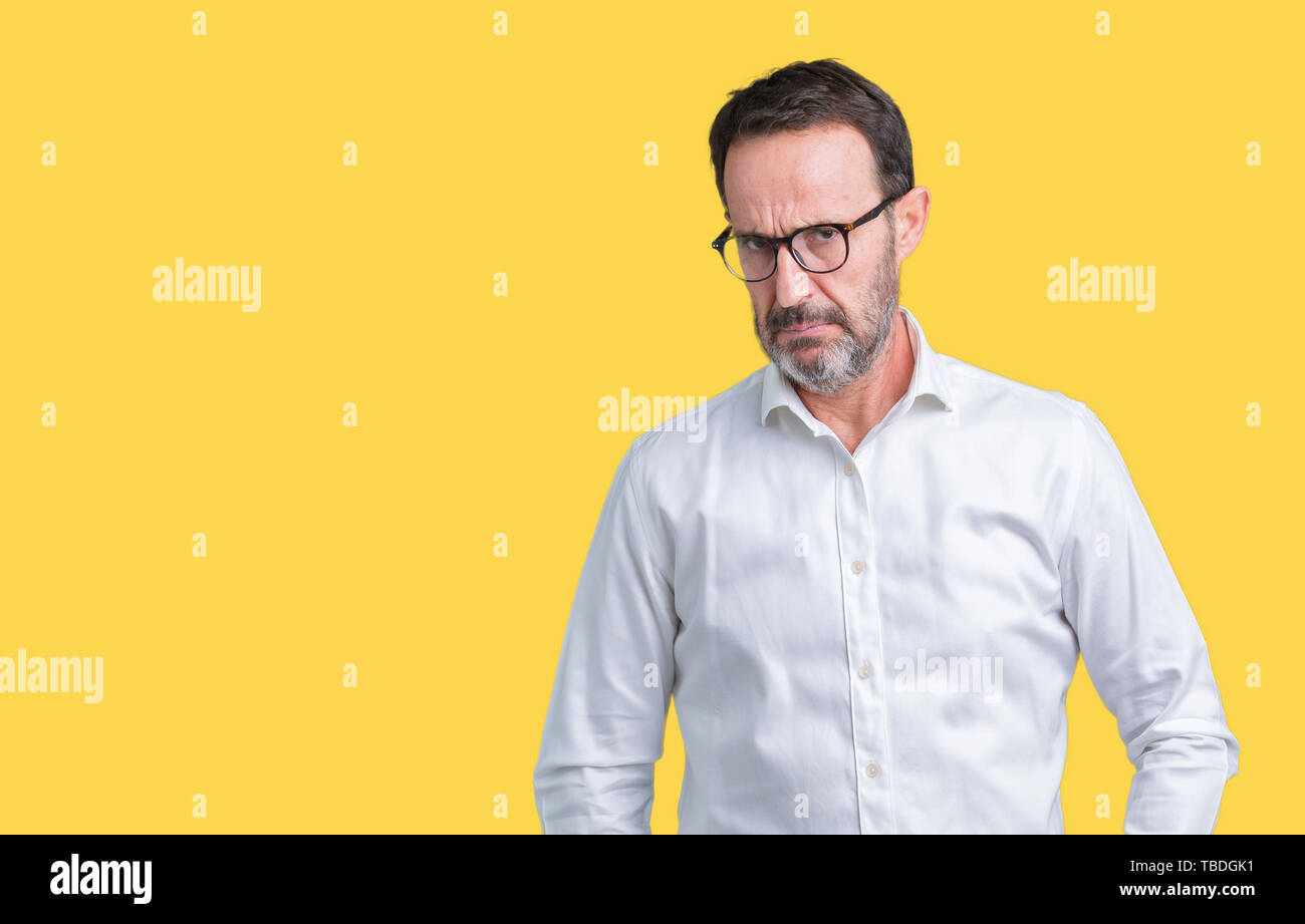 Handsome middle age elegant senior business man wearing glasses over isolated background skeptic and nervous, frowning upset because of problem. Negat Stock Photo