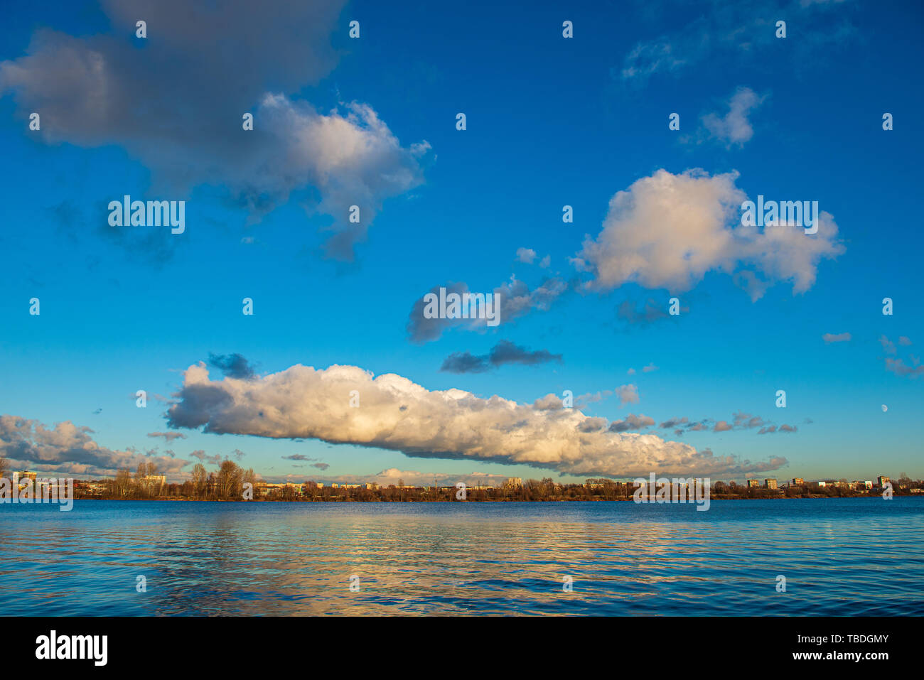 clear sky with dramatic clouds over the lake in sunset. countryside ...