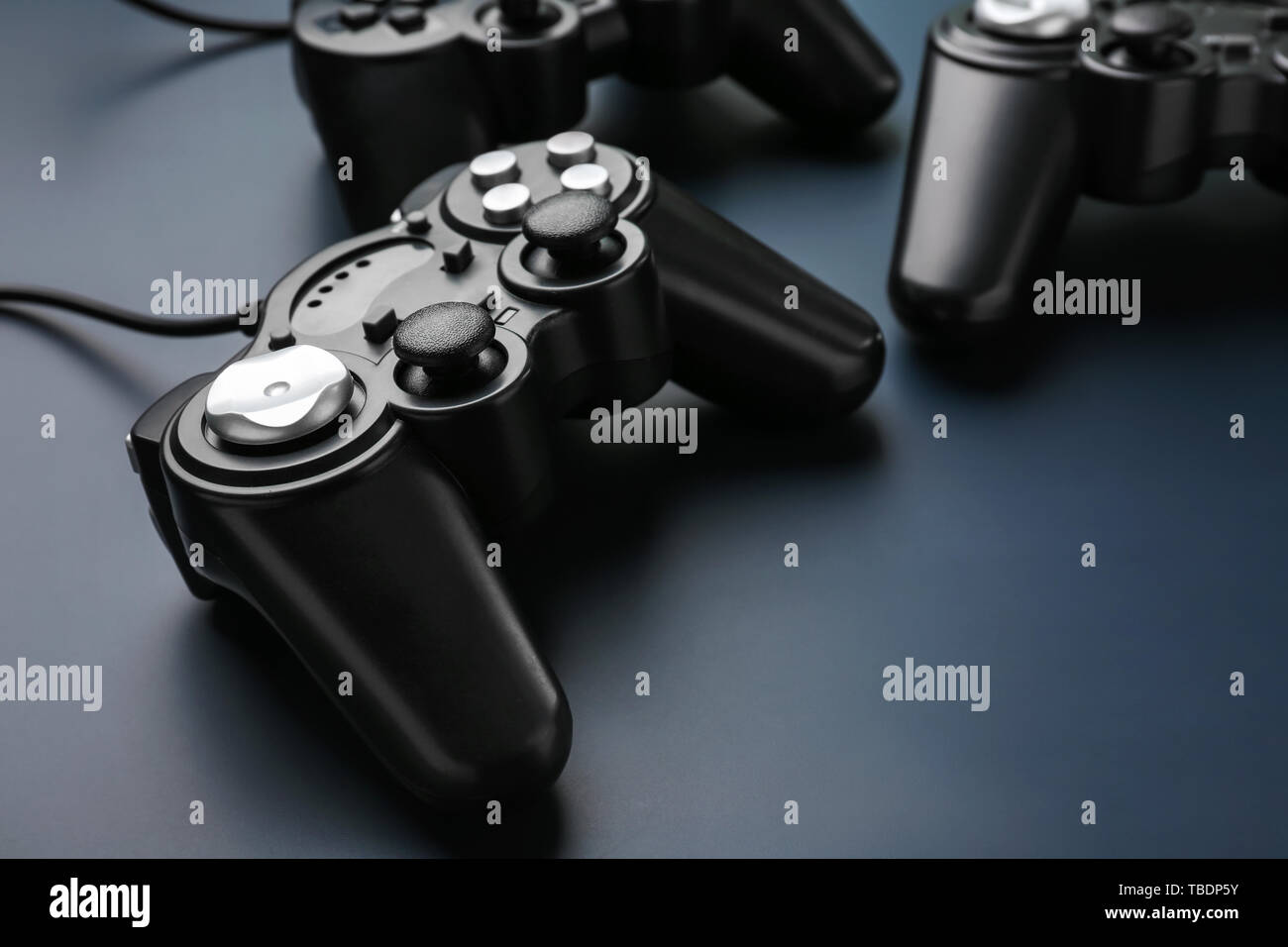 Modern game pads on dark background Stock Photo - Alamy