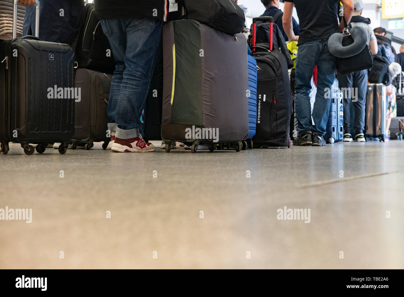 Berlin, Germany. 24th May, 2019. Travellers stand at a gate at Tegel Airport and wait for check-in. Credit: Paul Zinken/dpa/Alamy Live News Stock Photo