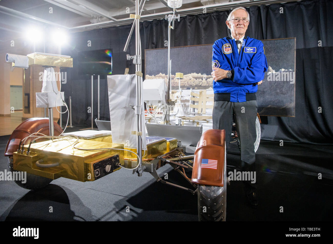 Munich, Germany. 01st June, 2019. Charlie Duke, former US astronaut, is standing in front of a replica of a moon car (Lunar Roving Vehicle) at a press conference for the 50th anniversary of the moon landing in the Deutsches Museum. In the background you can see the oil painting 'Ideal Moon Landscape' from 1919 by Wilhelm Kranz. Duke is one of four people who were on the moon and can still talk about it. Credit: Matthias Balk/dpa/Alamy Live News Stock Photo