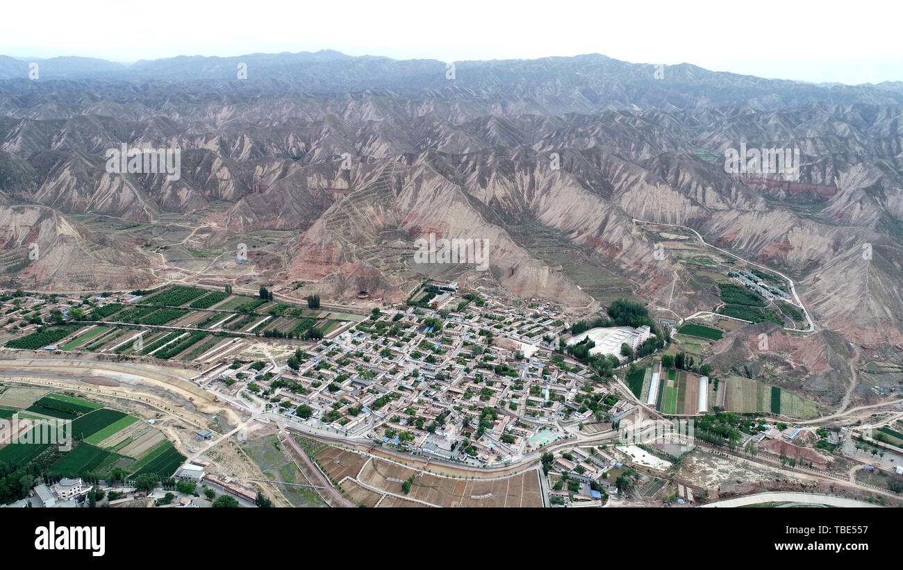(190601) -- BAIYIN, June 1, 2019 (Xinhua) -- Aerial photo taken on May 29, 2019 shows a view of Qiangwan Village in Baiyin City, northwest China's Gansu Province. Villagers from Qiangwan Village are fond of Qinqiang opera, a folk Chinese opera in northwest China. Instead of performing the art on a roughly-built stage near the Jin'gou River beset by pollution in the past, Qinqiang opera enthusiasts are now able to show their talent at a pavilion along the clean river thanks to ecological governance around the river launched by local government since 2018. In recent years, Qiangwan Village Stock Photo
