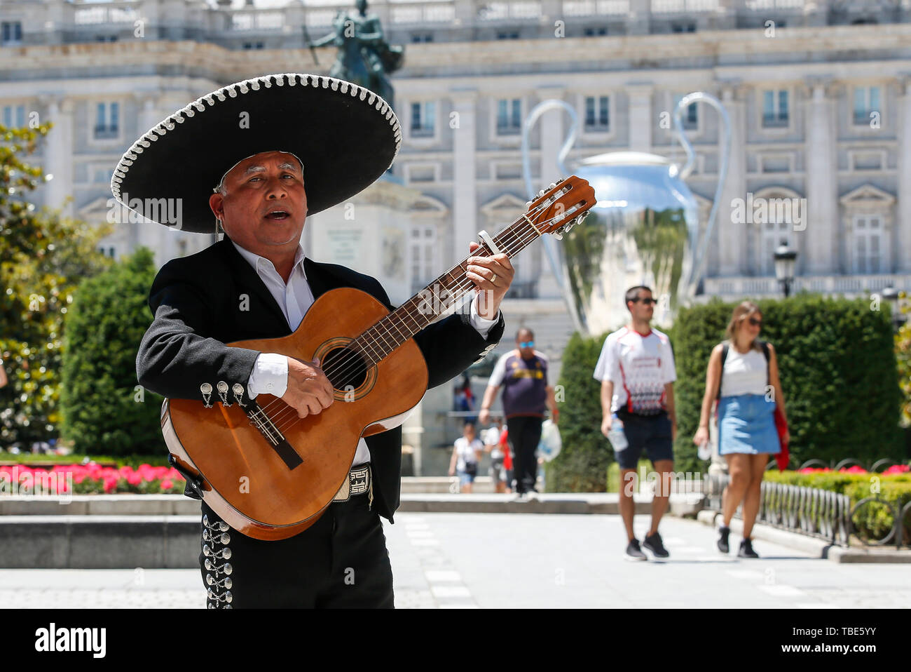 Madrid, Spain. 01st June, 2019. A man plays the Spanish Guitar in front of  the giant Champions League trophy at the Royal Palace prior to the UEFA  Champions League Final match between