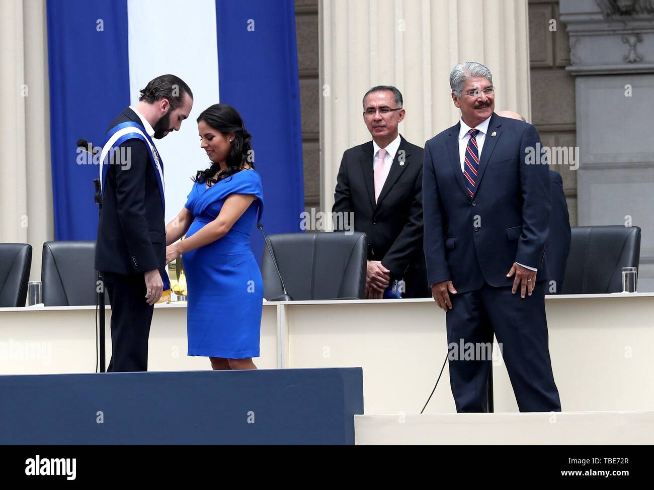 san salvador el salvador 01st june 2019 gabriela rodriguez 2l accommodates the presidential band of her husband entrepreneur nayib bukele l after he assumed the presidency of el salvador for the 2019 2024