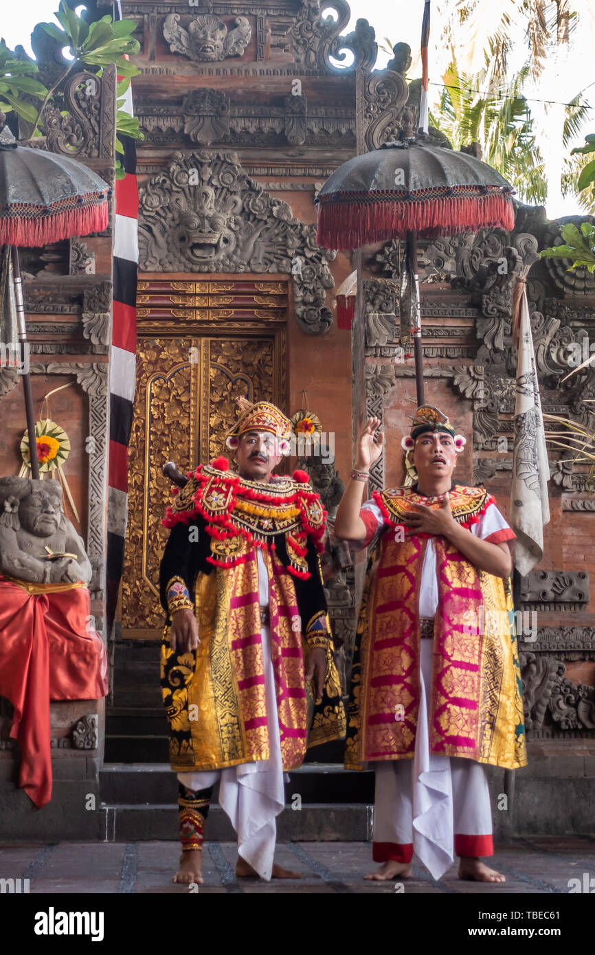 Banjar Gelulung, Bali, Indonesia - February 26, 2019: Mas Village. Play on stage setting. Two Mandarins in elaborated decorated red and yellow garment Stock Photo