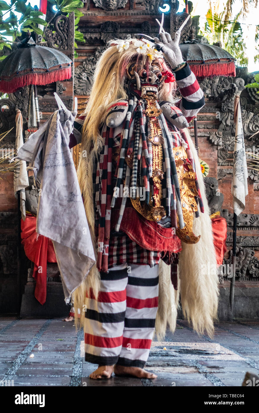 Banjar Gelulung, Bali, Indonesia - February 26, 2019: Mas Village. Play on stage setting. Closeup of monster with mask and long blond hair stading on  Stock Photo