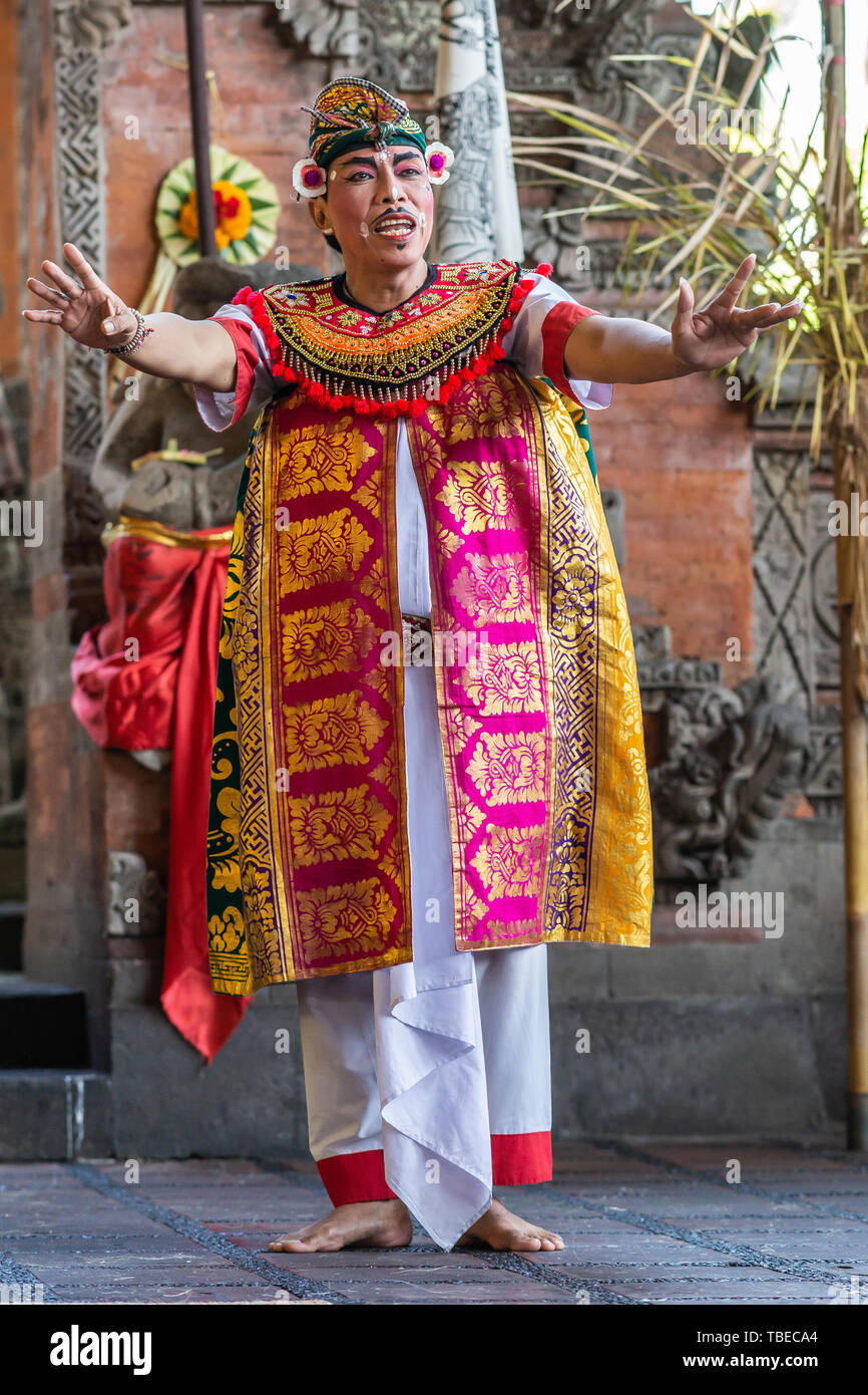 Banjar Gelulung, Bali, Indonesia - February 26, 2019: Mas Village. Play on stage setting. Closeup of Mandarin in traditional garb with pinks, golds, b Stock Photo
