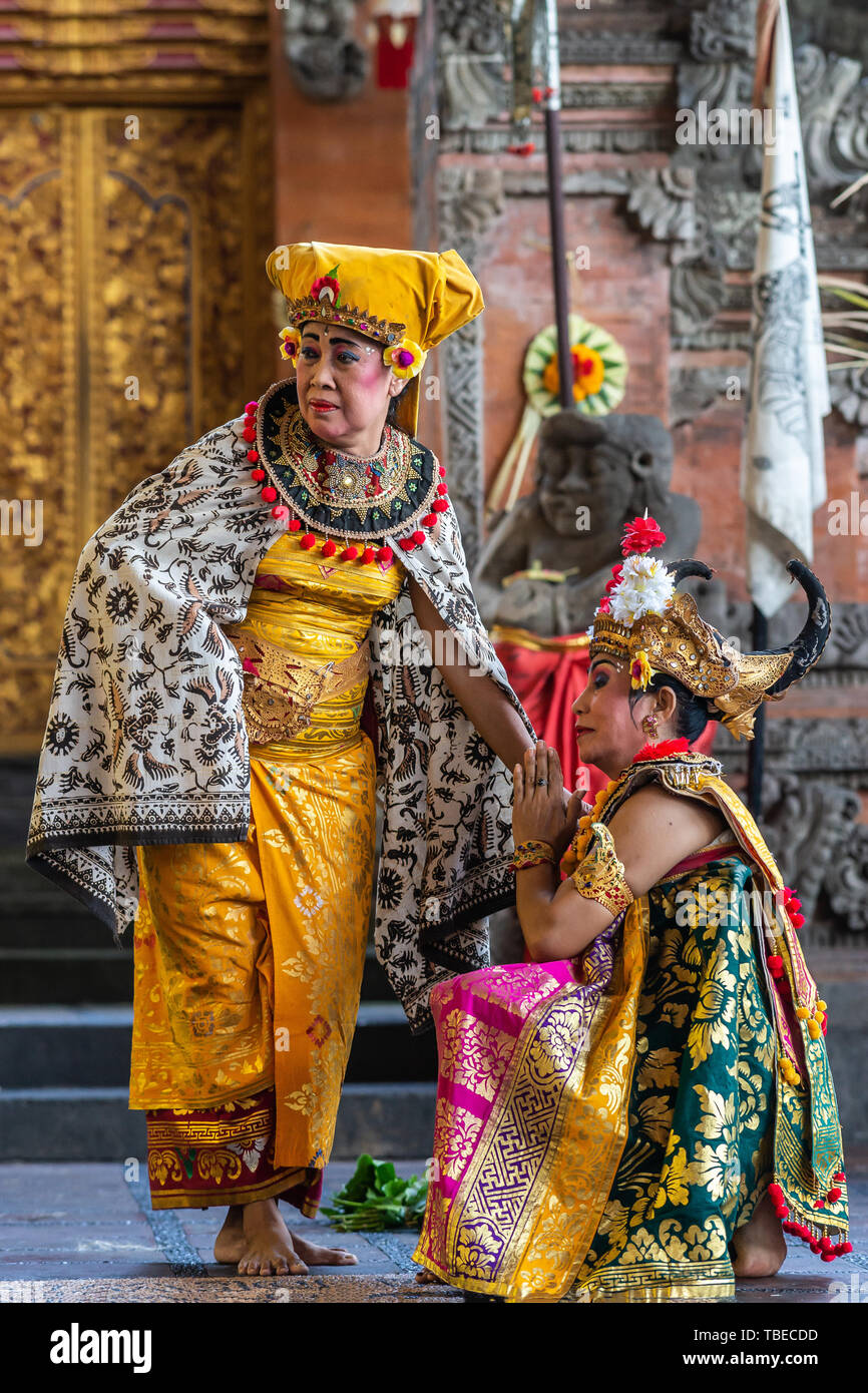 Banjar Gelulung, Bali, Indonesia - February 26, 2019: Mas Village. Play on stage setting. Closeup of two Queens in traditional garb with golds, blacks Stock Photo