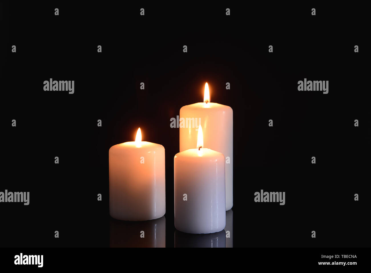 Burning candles on black background Stock Photo - Alamy