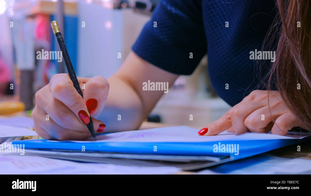 Fashion designer drawing design sketch Stock Photo - Alamy