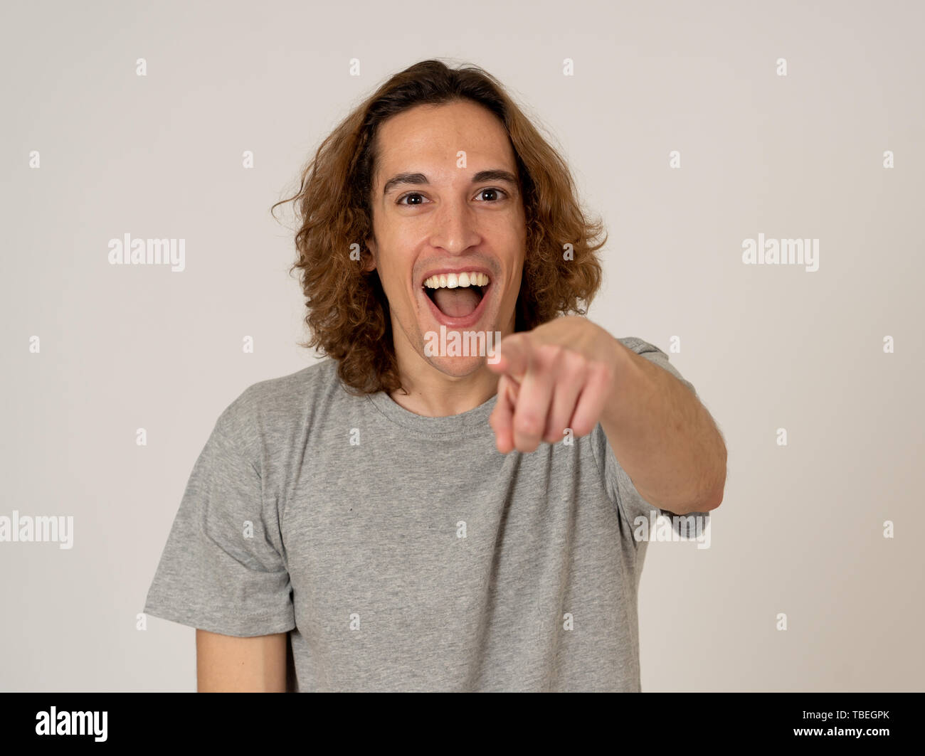 Portrait of Amazed excited funny millennial man pointing at something ...
