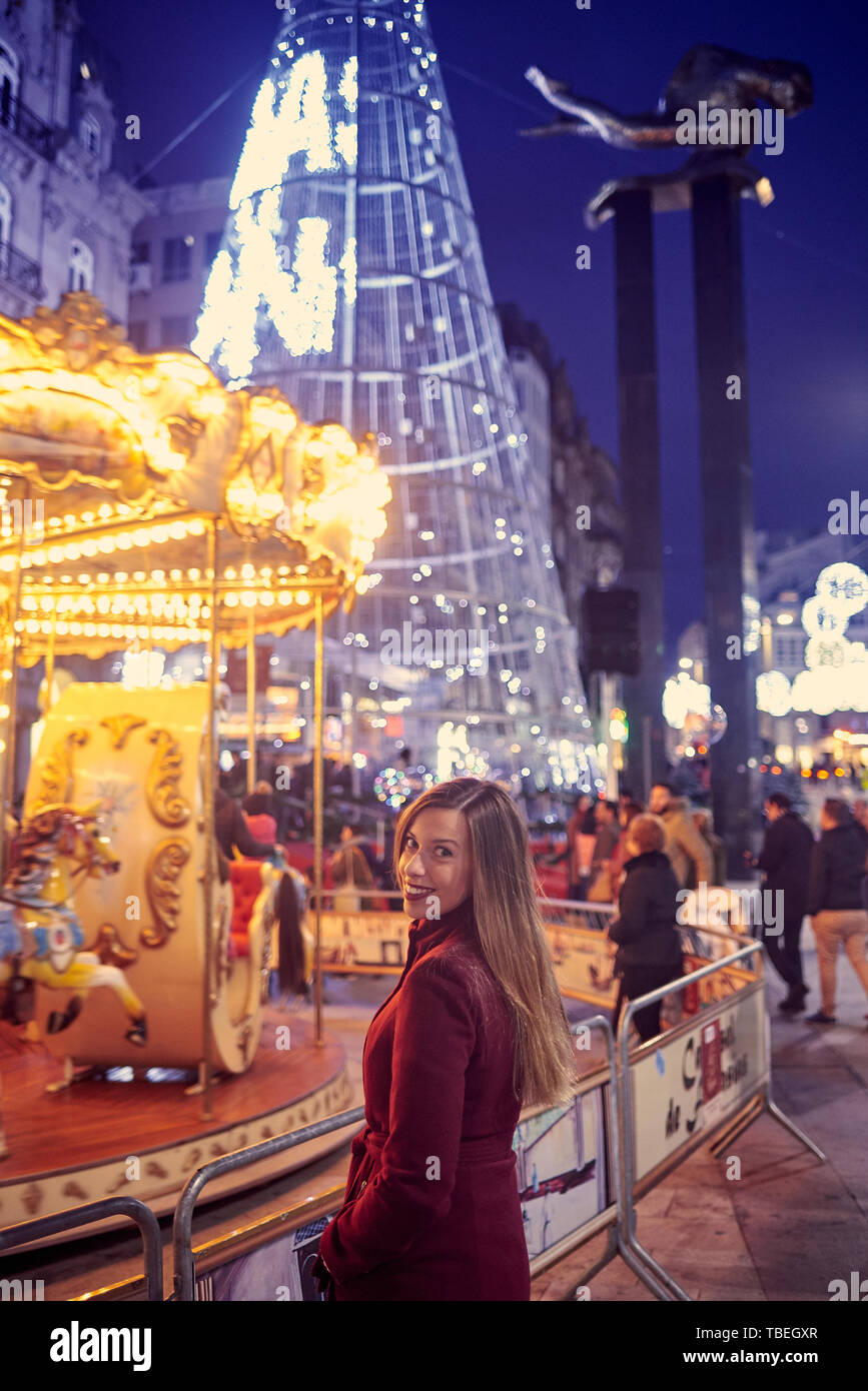 Young woman enjoying christmas lighting in Vigo Stock Photo