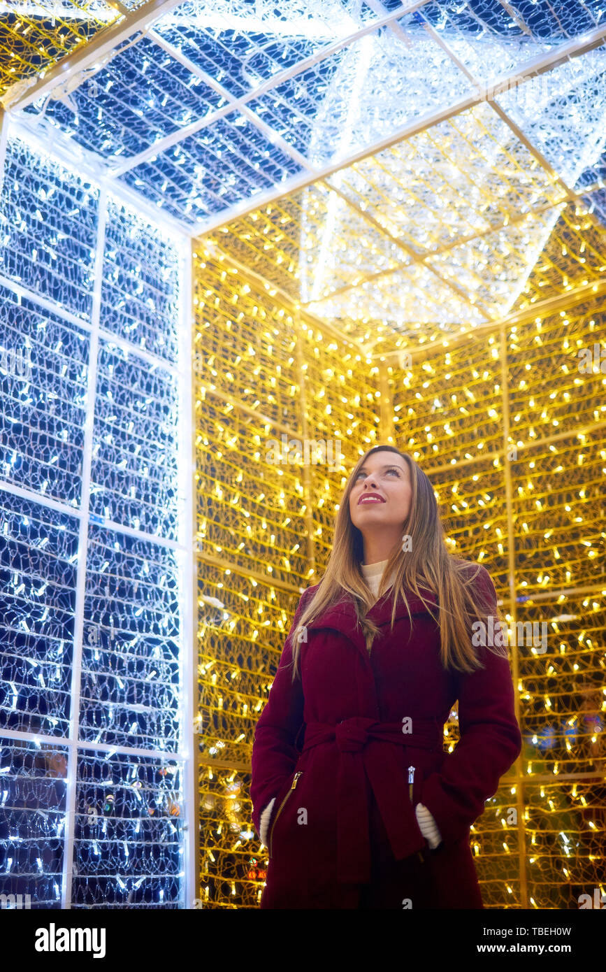 Young woman enjoying the Christmas lighting in Vigo, Galicia, Spain Stock Photo
