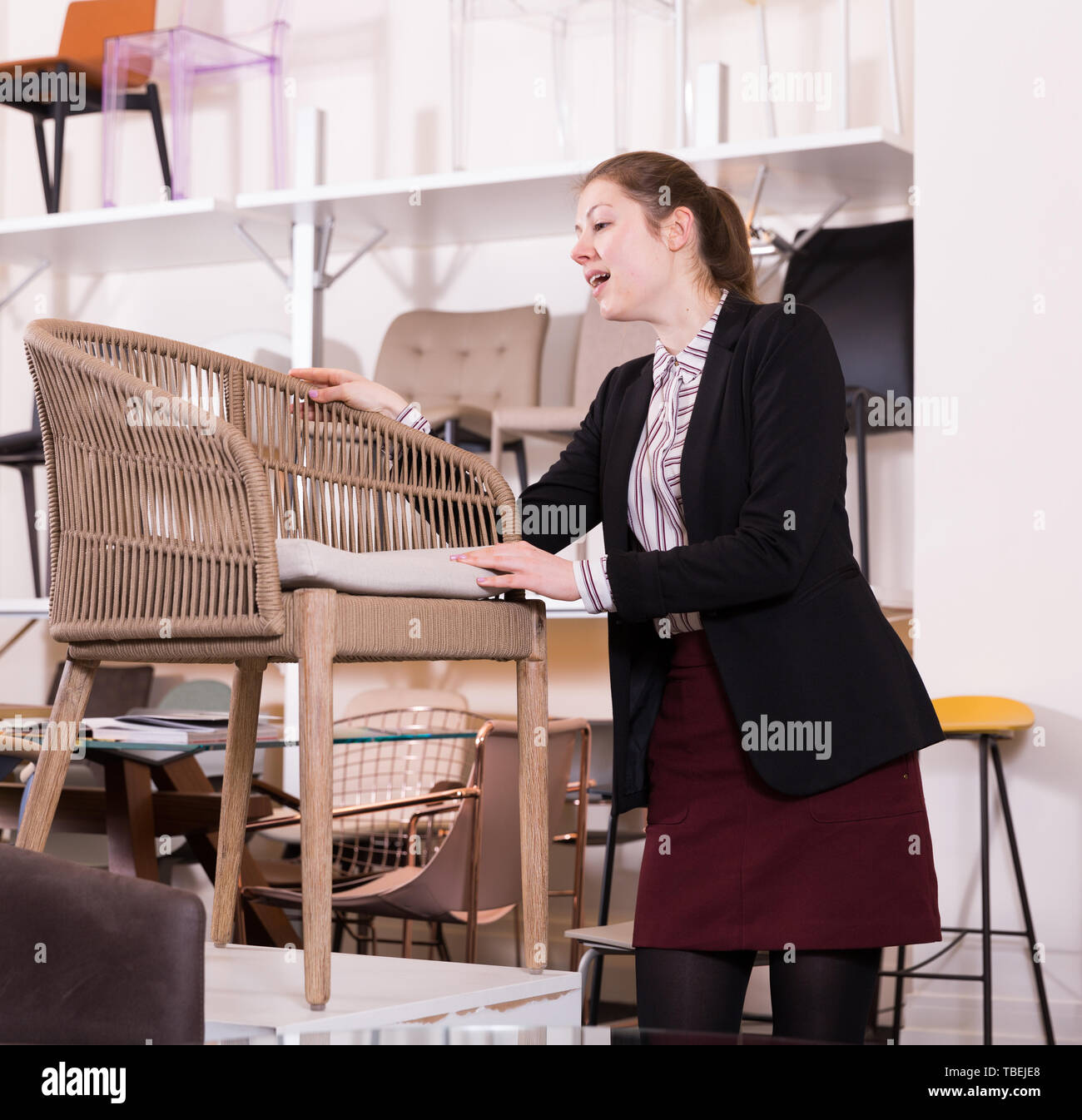 Smiling Girl Visiting Furniture Store In Search Of New Comfortable